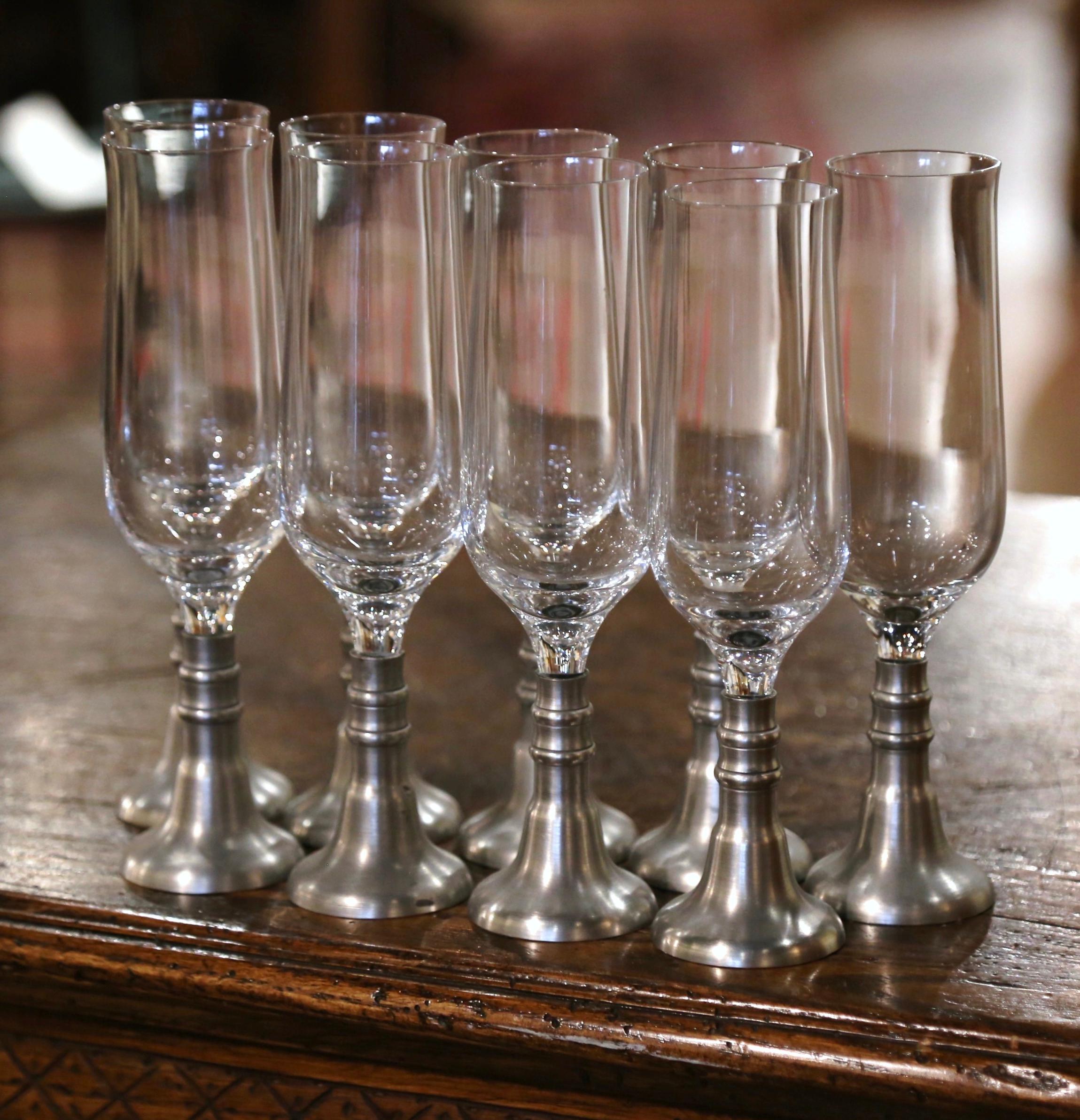 Serve Champagne in style with these vintage flutes. Created in France circa 1970, each glass stands on a circular pewter base. The set of 9 flutes are in excellent condition.
Measure: 8.25