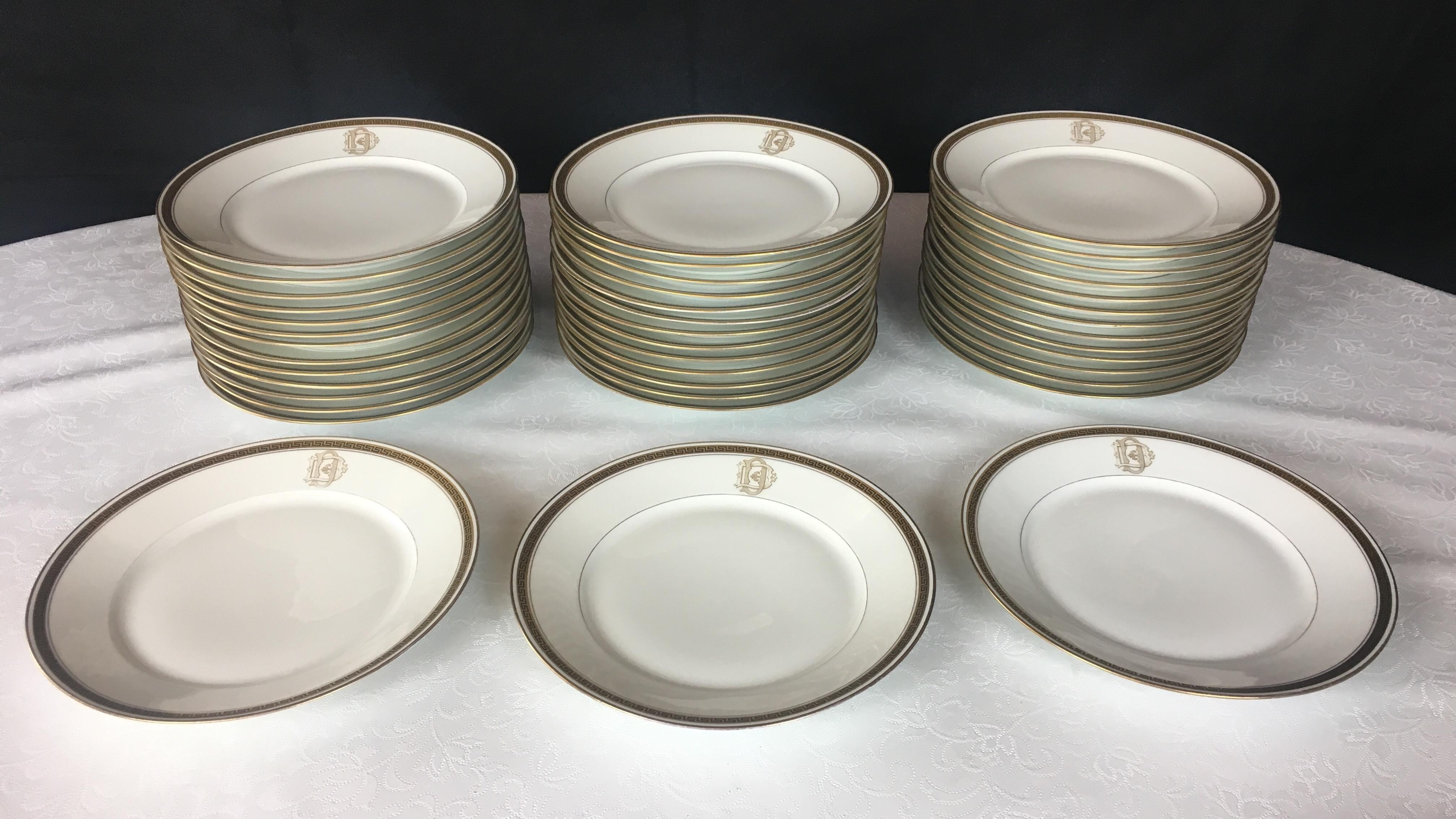An exceptionally beautiful 98 piece French Limoges dinner service. Trimmed with brilliant gold bands, this set is in excellent antique condition. It is monogrammed with the letter 