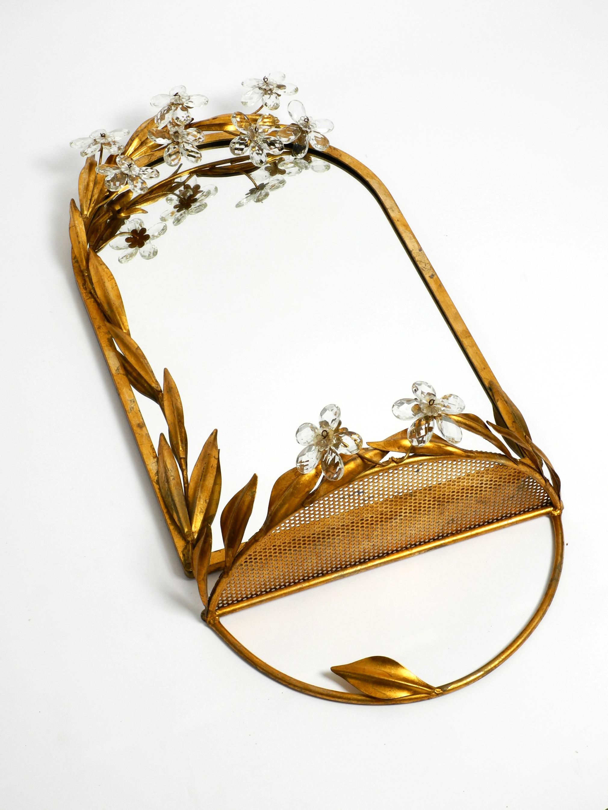 Beautiful, rare original 1960s floral iron wall mirror with shelf, gold-plated.
Many details with glass leaves and flowers on the mirror above and on the shelf.
Manufactured by Banci Firenze in the 1960s. Made in Italy.
Elaborate production with