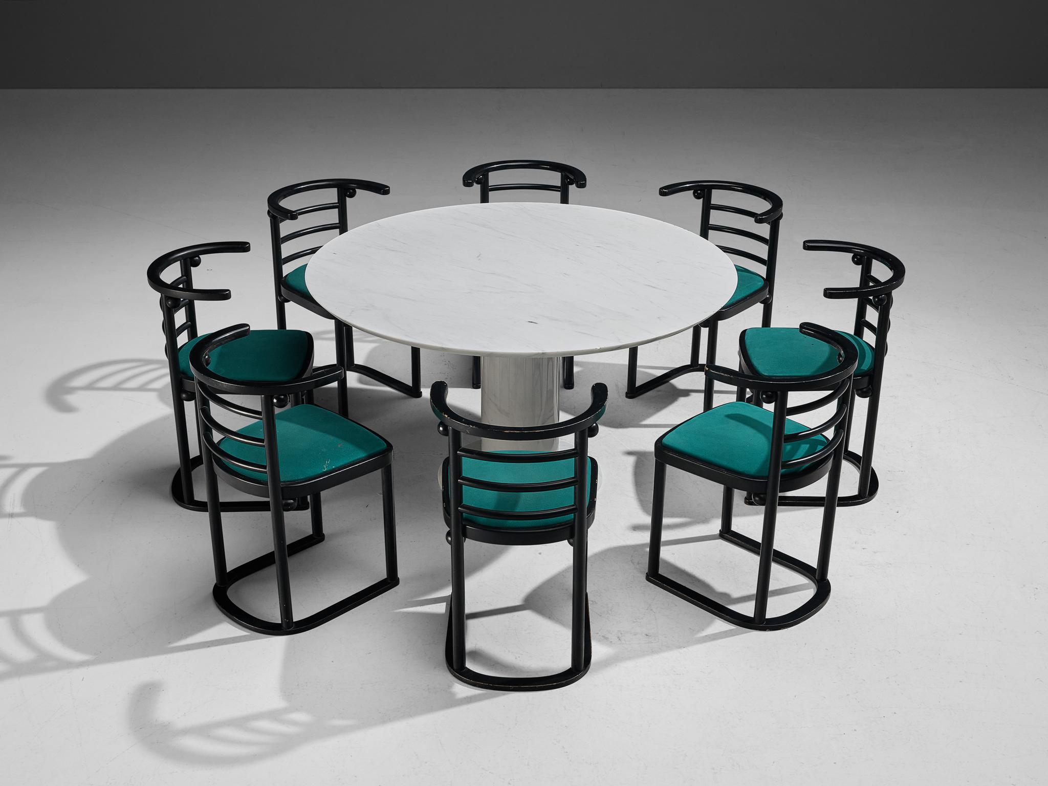 Set of a round marble dining table and eight dining chairs 
Round dining table, white marble, Italy, 1960s

This table is a skilful example of postmodern design. One solid marble pedestal holds a minimalistic table top a great classic for a