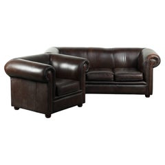 Set of a smooth chesterfield sofa and armchair with a timeless English look