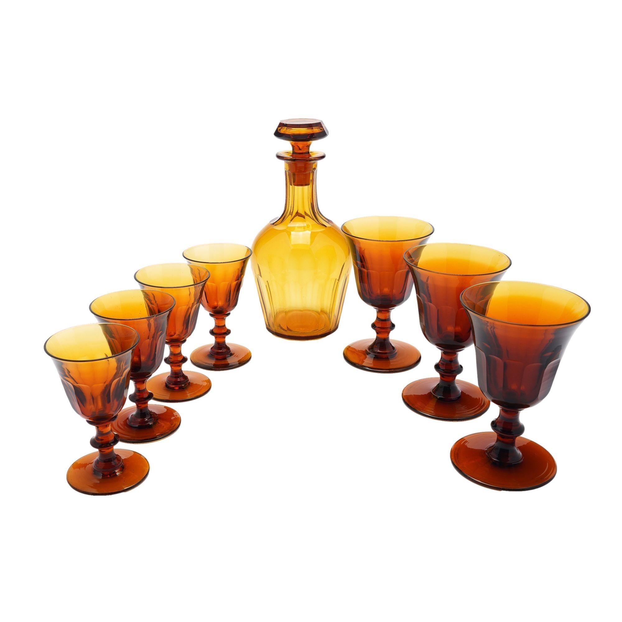 Assembled group of amber glassware attributed to Phineas Dummer of Jersey City, New Jersey.

-One blown and slice cut decanter with facet cut mushroom stopper.
-Set of four amber blown and slice cut glass sherry glasses of bell shaped bowl on a