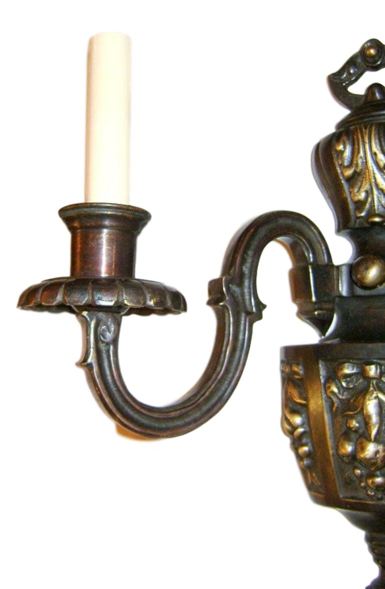 Set of eight circa 1920s American patinated bronze sconces with fruit and foliage motif. Sold in pairs.

Measurements:
Height 14