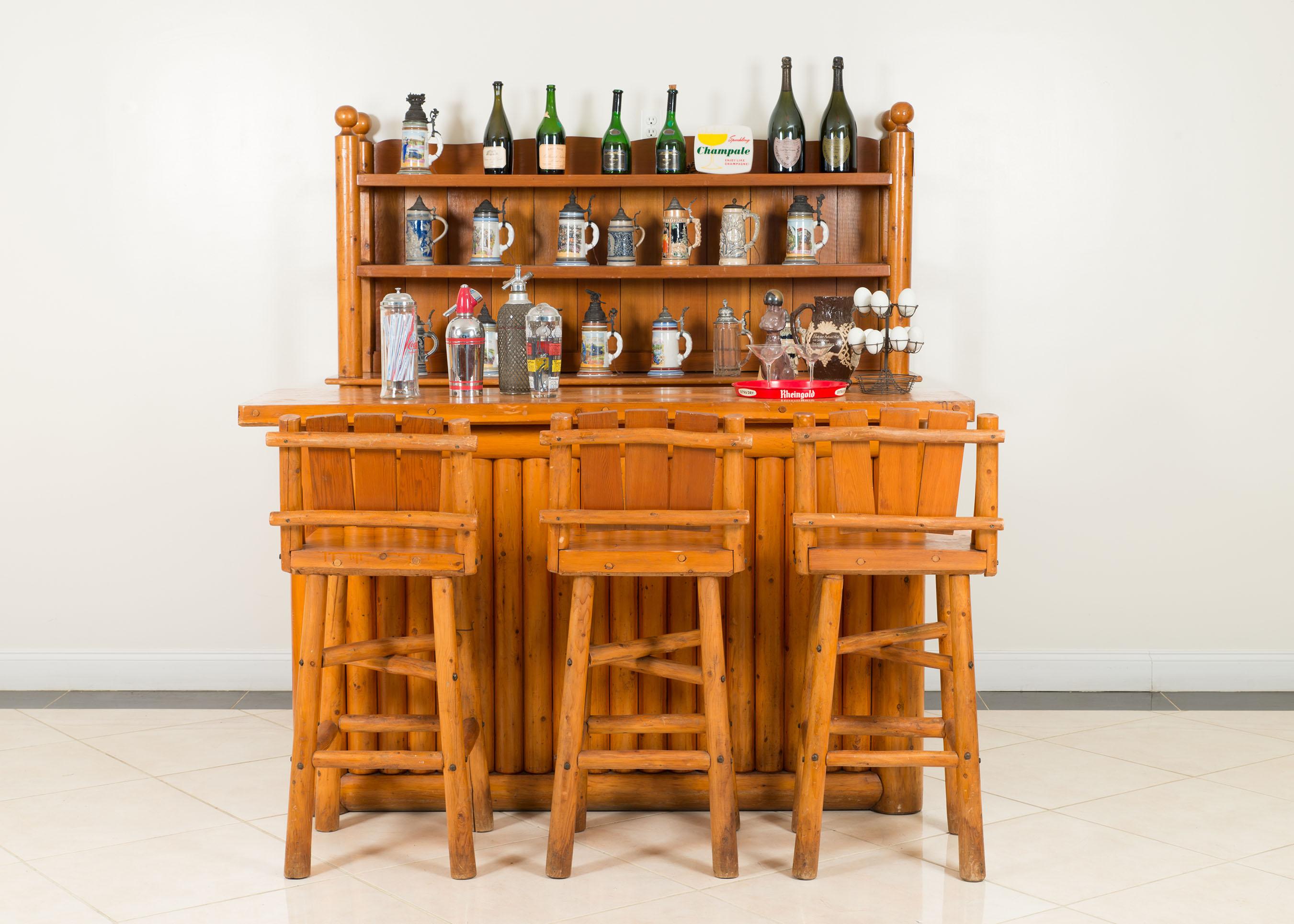 Set of American Old Hickory style (1950s) cedar bar furniture including a 2 section back bar cabinet, 4 bar stools, & a bar with a fluted front design (by RITTENHOUSE) (Available individually: bar: 060874, back bar: 060875, 4 stools: 060876)
