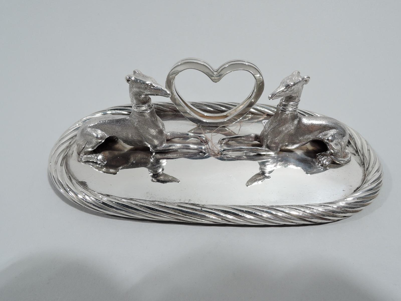 Set of 13 American Modern sterling silver place card holders, ca 1950. This set comprises 12 place card holders and 1 menu holder. Each: Cast figure of recumbent whippet with gracile limbs and imperious pointy head mounted to oval base with applied