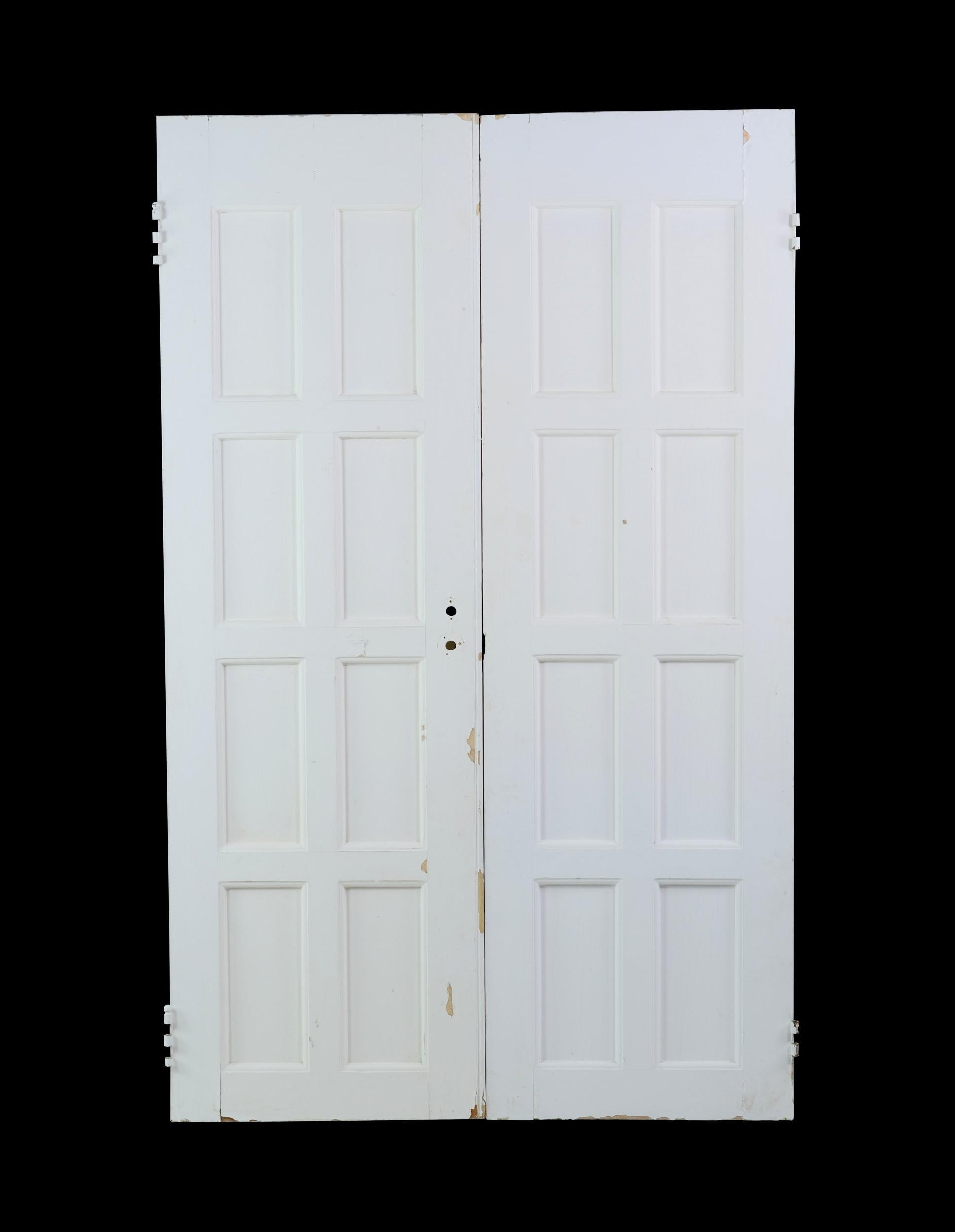 Antique set of wood double doors featuring 8 recessed vertical panes each. They are painted white and have some chipping. Please see photos. Priced as a double. Priced as a set of 2. Measures: 67