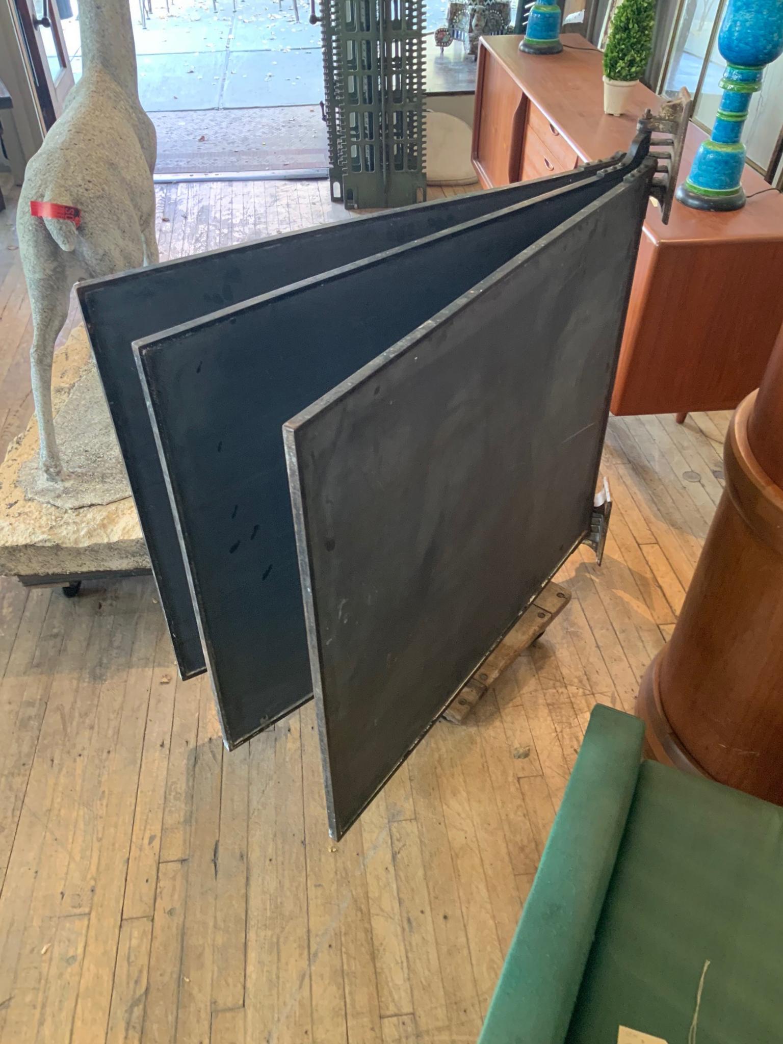 An outstanding set of antique slate chalkboards in their original frames with cast iron corners, along with the cast iron wall-mounted brackets that hold them all and allow them to pivot to use both sides of the boards. Beautiful set in good