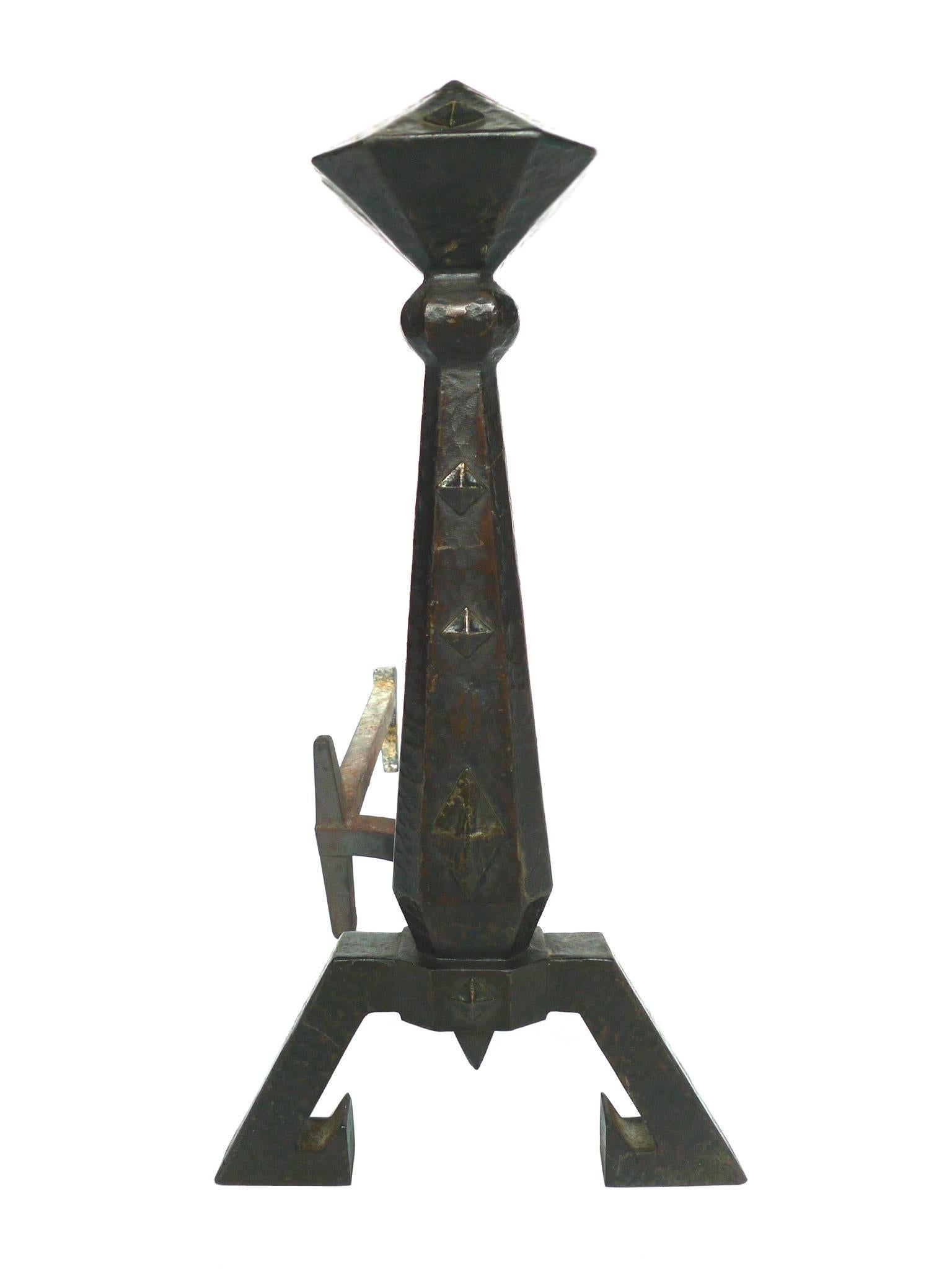 This cast-iron set includes a pair of andirons and one stand consisting of five tool pieces. The tools are for managing the fireplace and firewood. The set was expertly designed and crafted by the Bradley & Hubbard Manufacturing Company, which