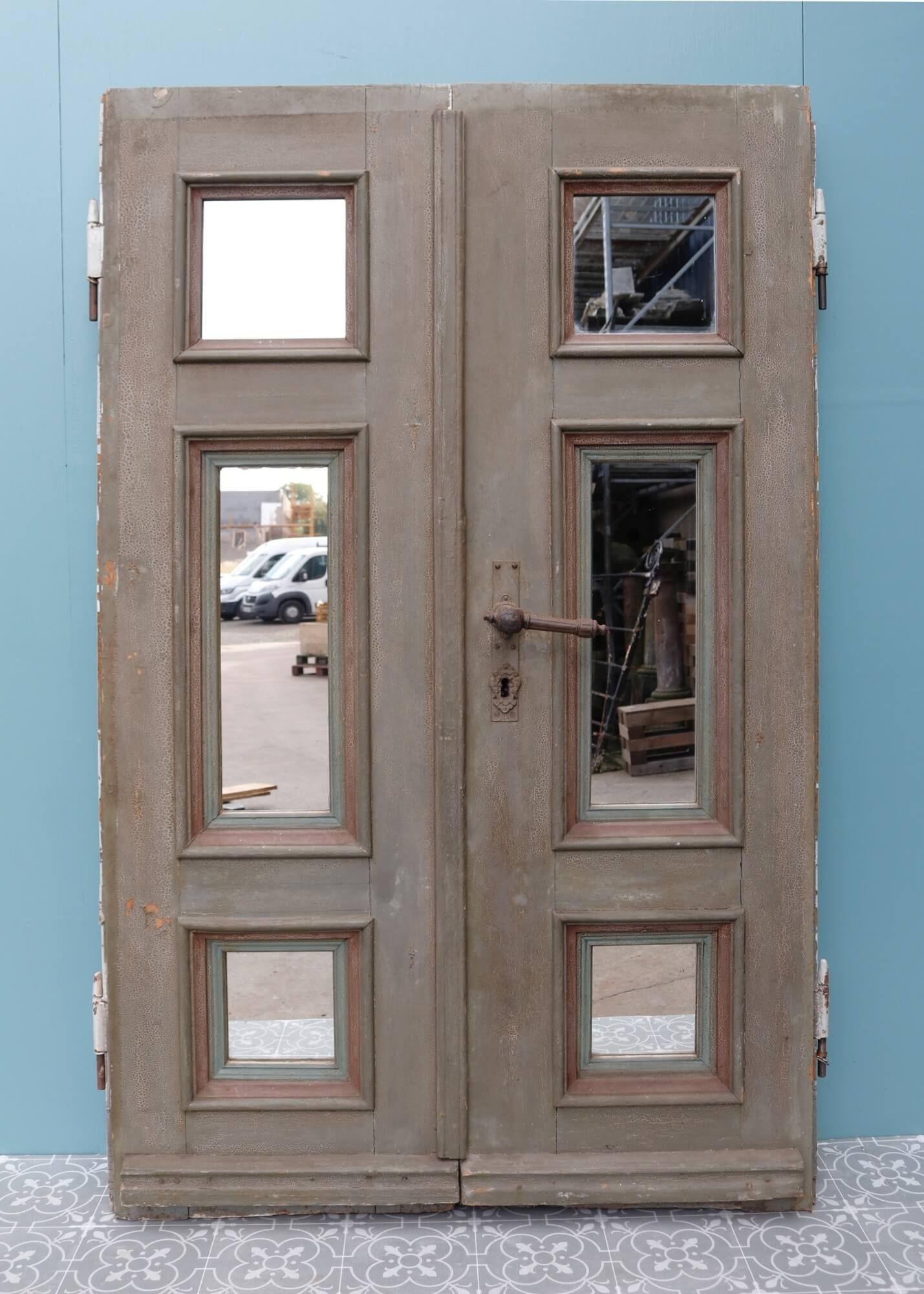 A set of German antique double doors dating from the late 19th century and later fitted with mirrors. These doors were likely once used as external doors but are now more suited to being tall cupboard or wardrobe doors thanks to their mirrored