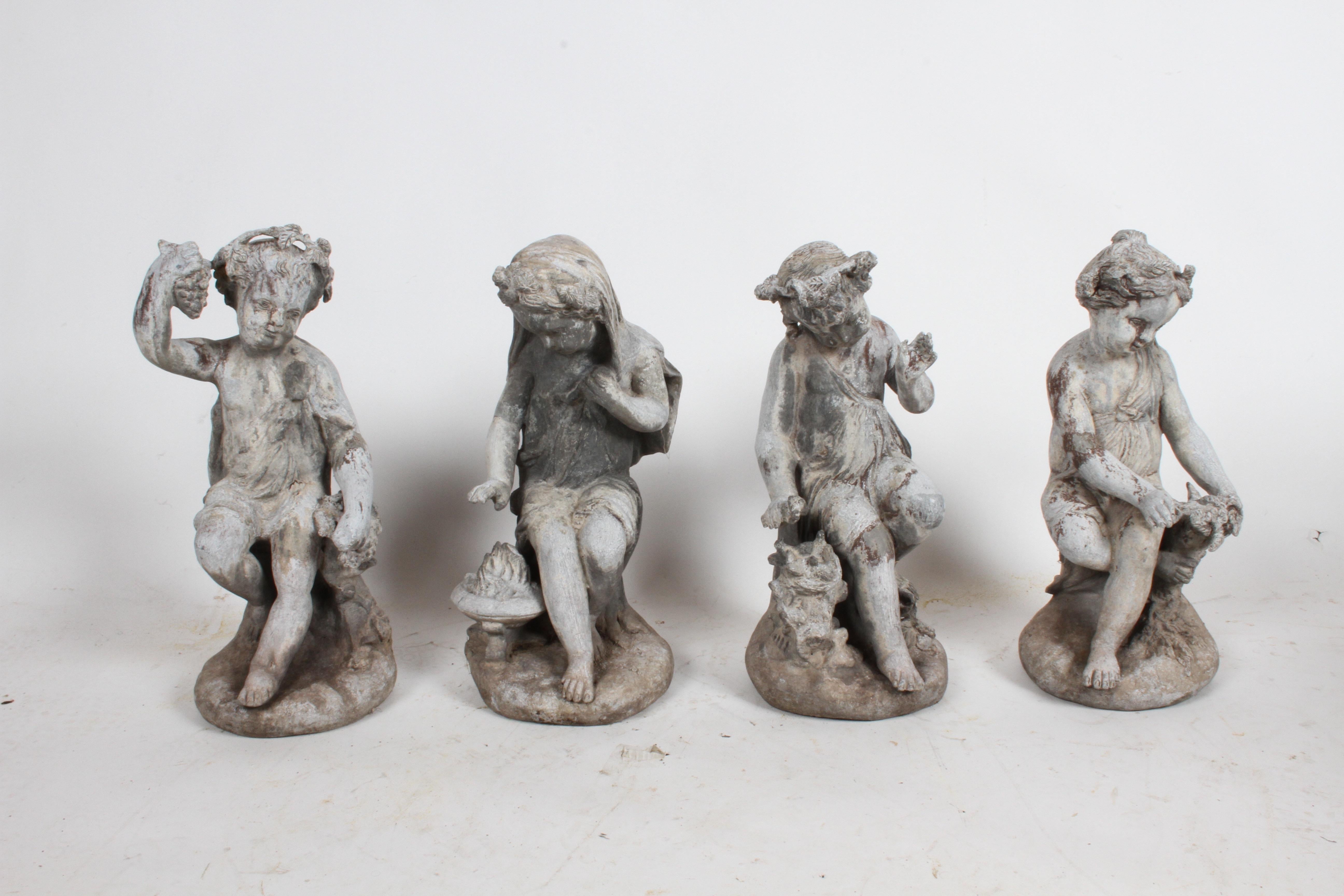 Complete set of antique English garden Four Seasons lead figures, late 19th or early 20th century. Four lead cast children, two girls and two boys, spring: feeding baby birds, summer: with grapes, fall: with wheat and winter: in a robe with a fire