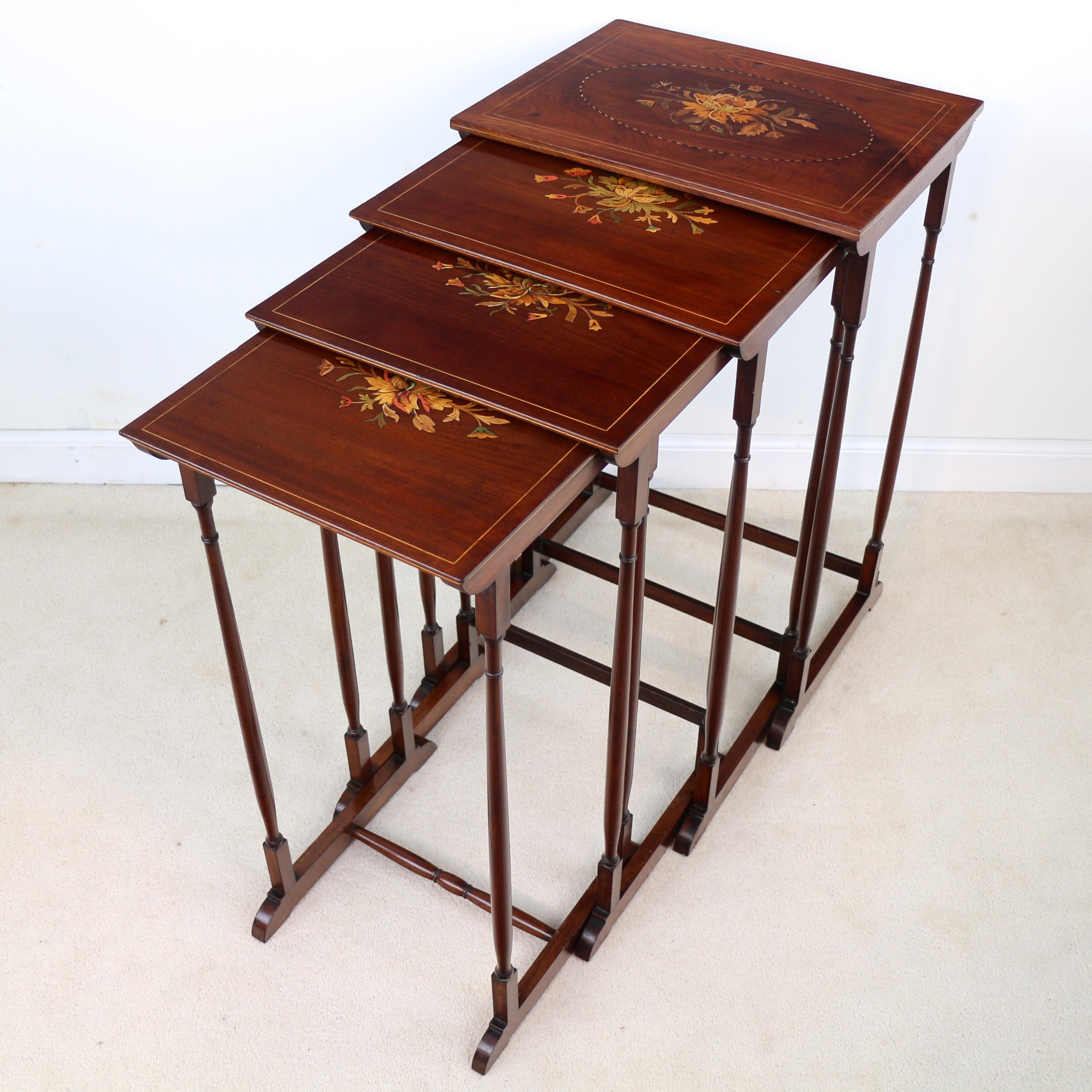 An attractive nest of Victorian mahogany and marquetry inlaid quartetto tables. Each inlaid to the top with floral sprays and boxwood stringing and further boxwood stringing to the side edges. Standing on slender ring turned tapering legs with
