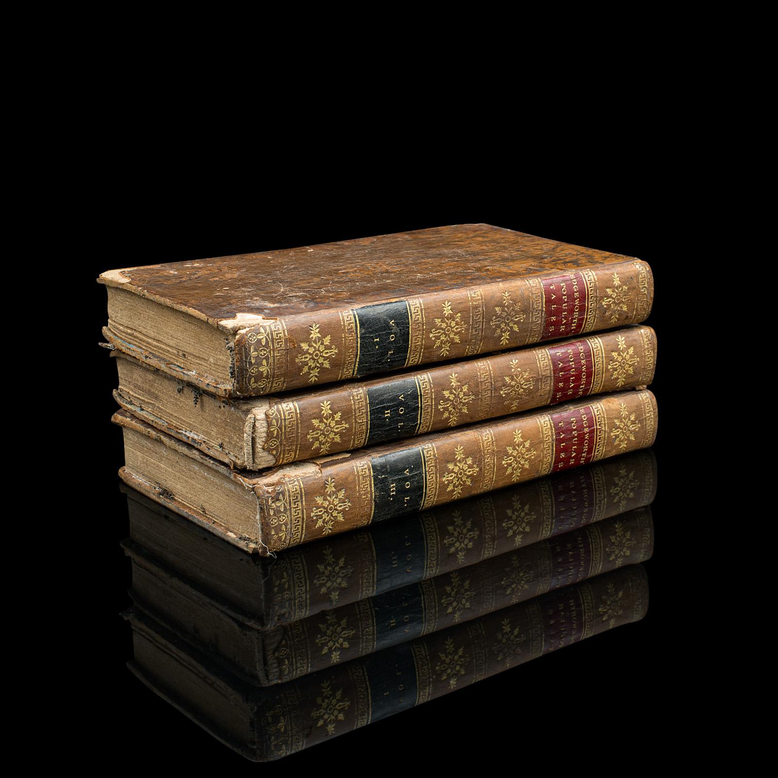 This is a set of 3 antique fiction books, Popular Tales by Maria Edgeworth. An English language, hard bound 3 volume set of novels, dating to the Georgian period, published 1814.

A prolific novelist of adult and children's literature, Maria