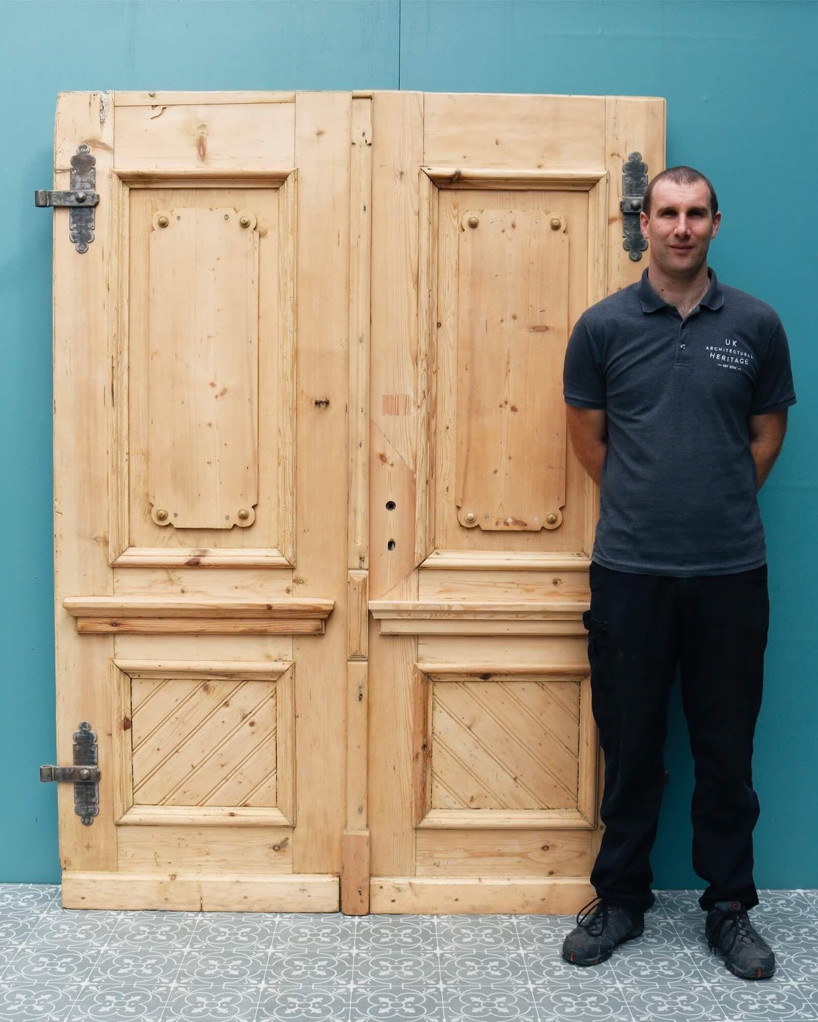 A character set of antique French pine double doors dating from circa 1870 suitable for internal or external use. Ornately crafted, these reclaimed double doors are certain to become a feature of any property, the scalloped Louis style top panels