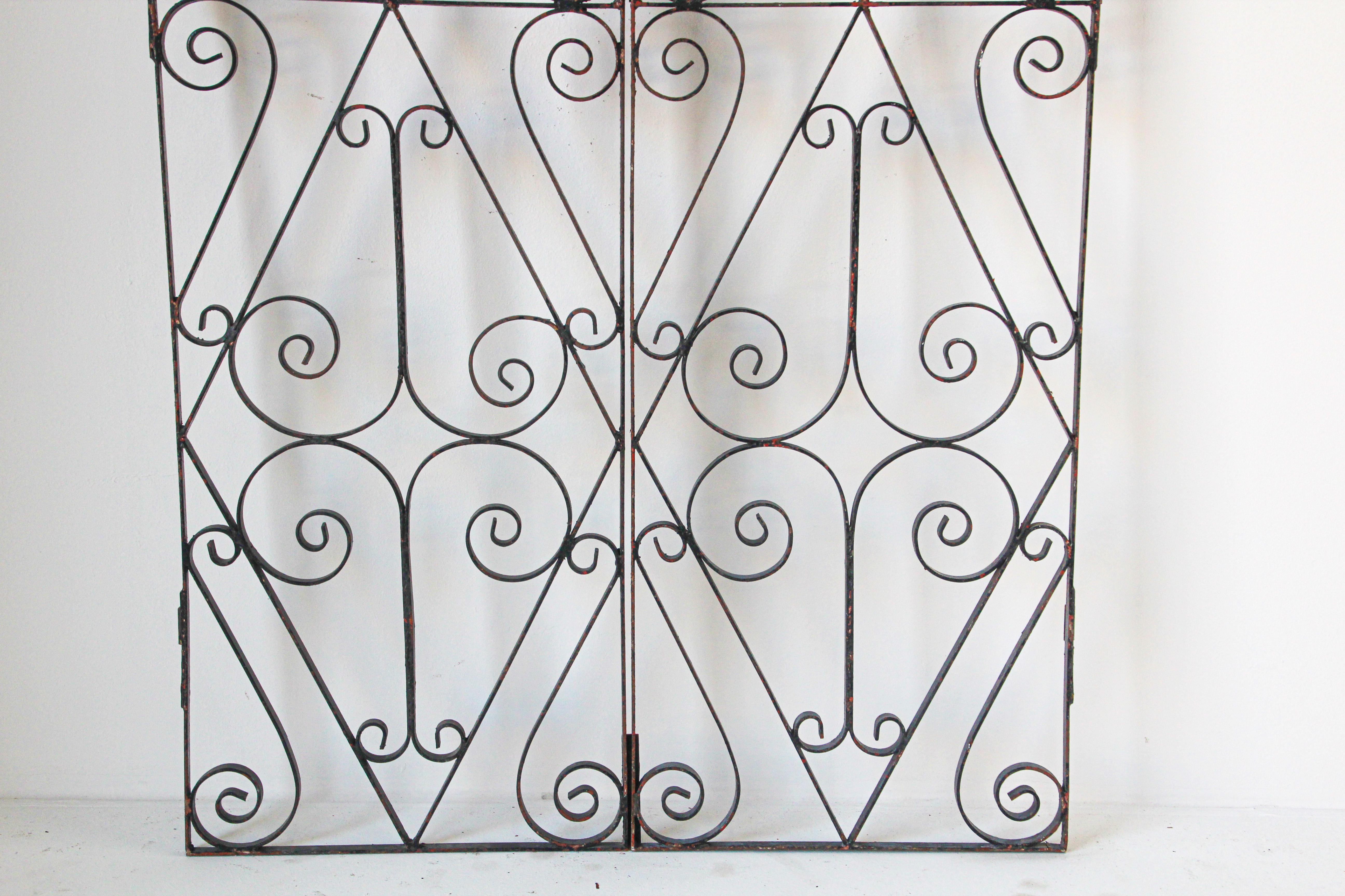 Antique French wrought iron garden gate, double doors.
A pair of good quality wrought iron gates with flowing scroll design.
All hinge eyes present.
Each door measure 20.75