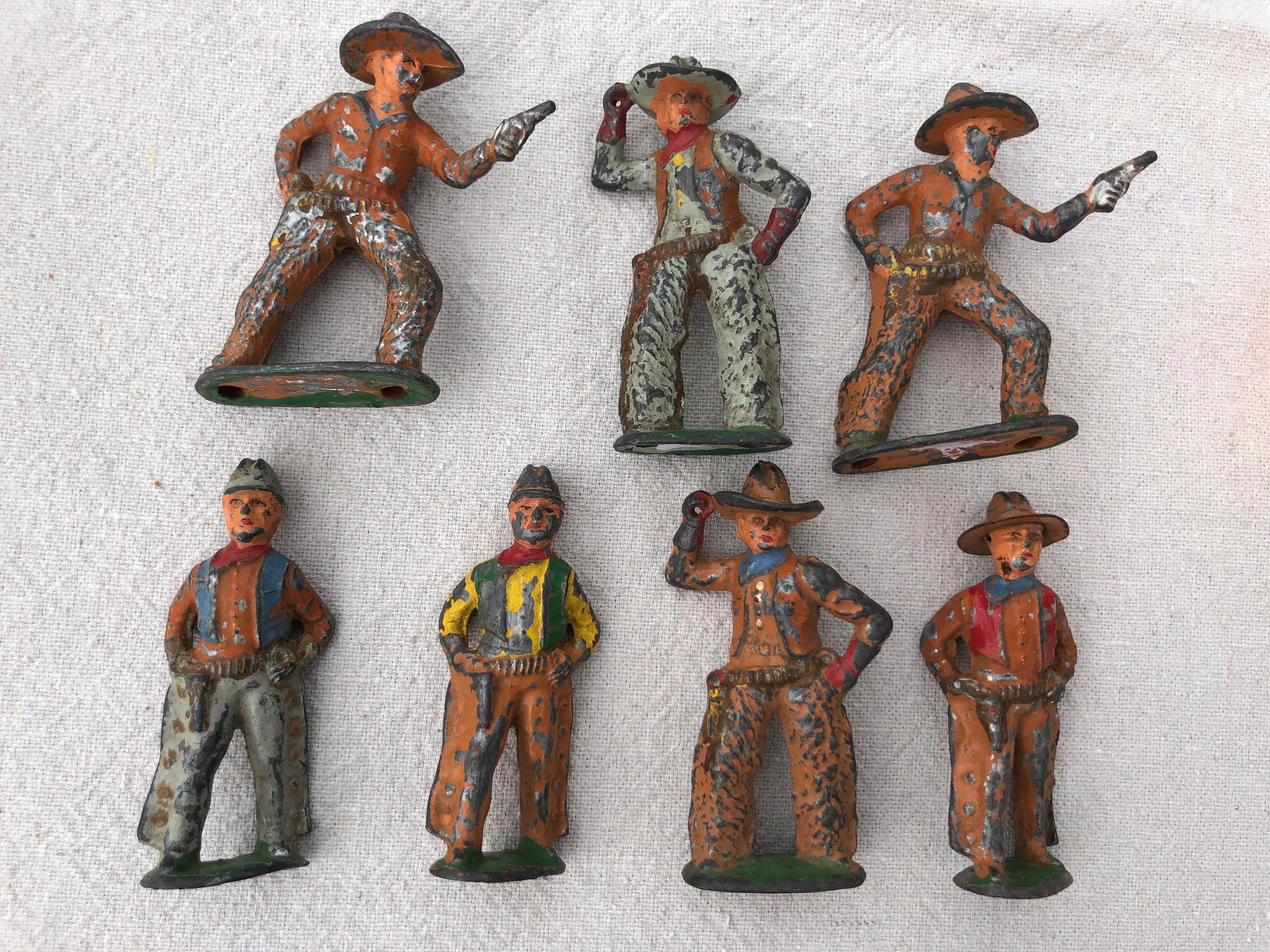 Set of 7 antique lead toy cowboys, circa 1950. Produced by BARCLAY MANOIL Maker of WESTERN TOYS .Vintage Polychromed paint finish. Perfect gift for that cowboy collector.
