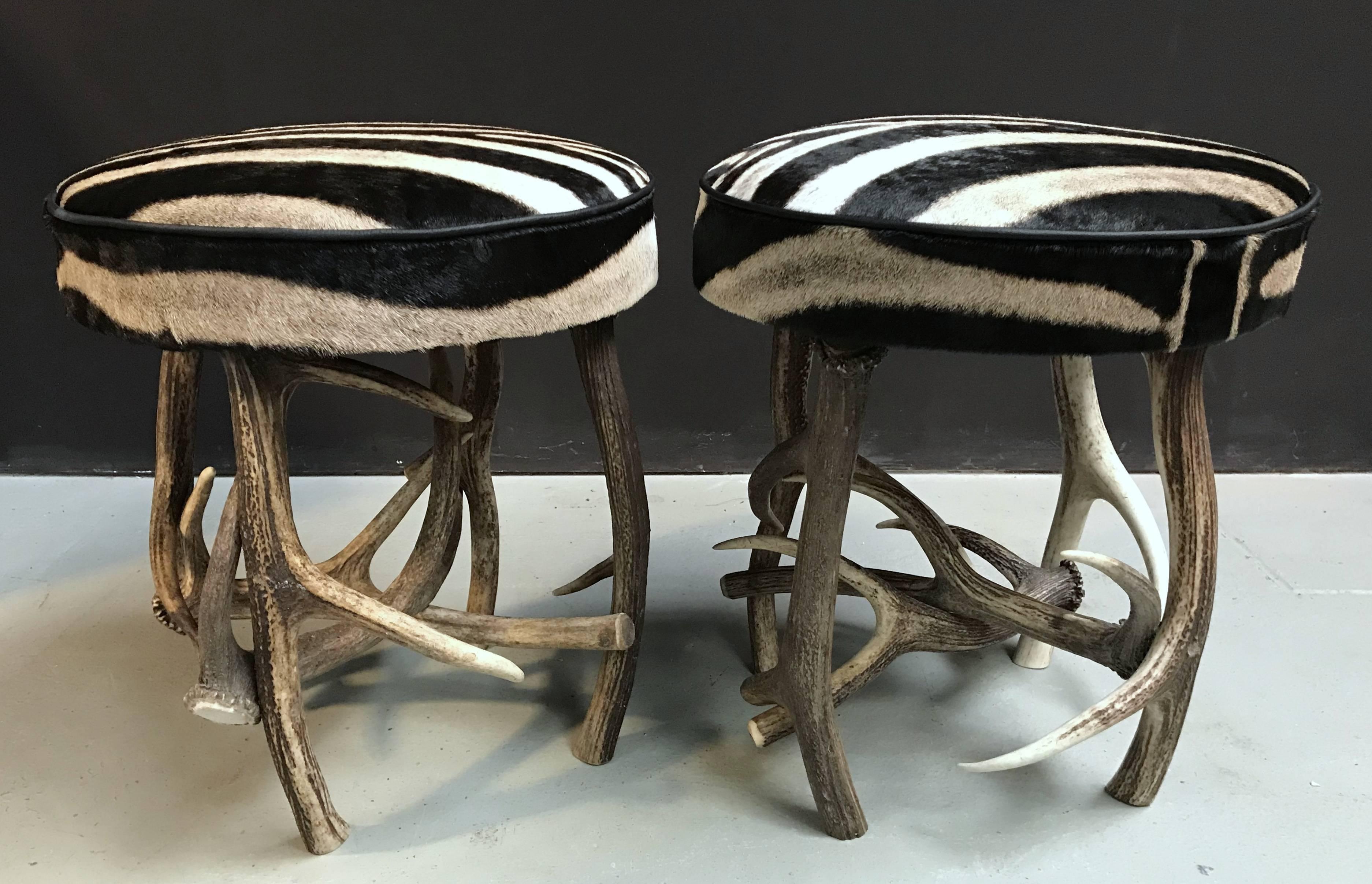 Set of stools, made from red deer antlers and the top is burchell zebra hide.
Both stools are made from the same zebra hide.
  