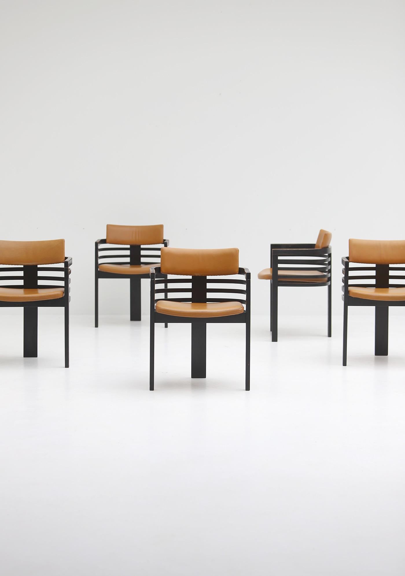 Set of six dining chairs designed by Jean Batenburg for MI, Belgium, in the 1970s. Produced for only a short time, they are now hard to find. The chairs have a strong, architectural look with a black lacquered plywooden frame and curved slats that
