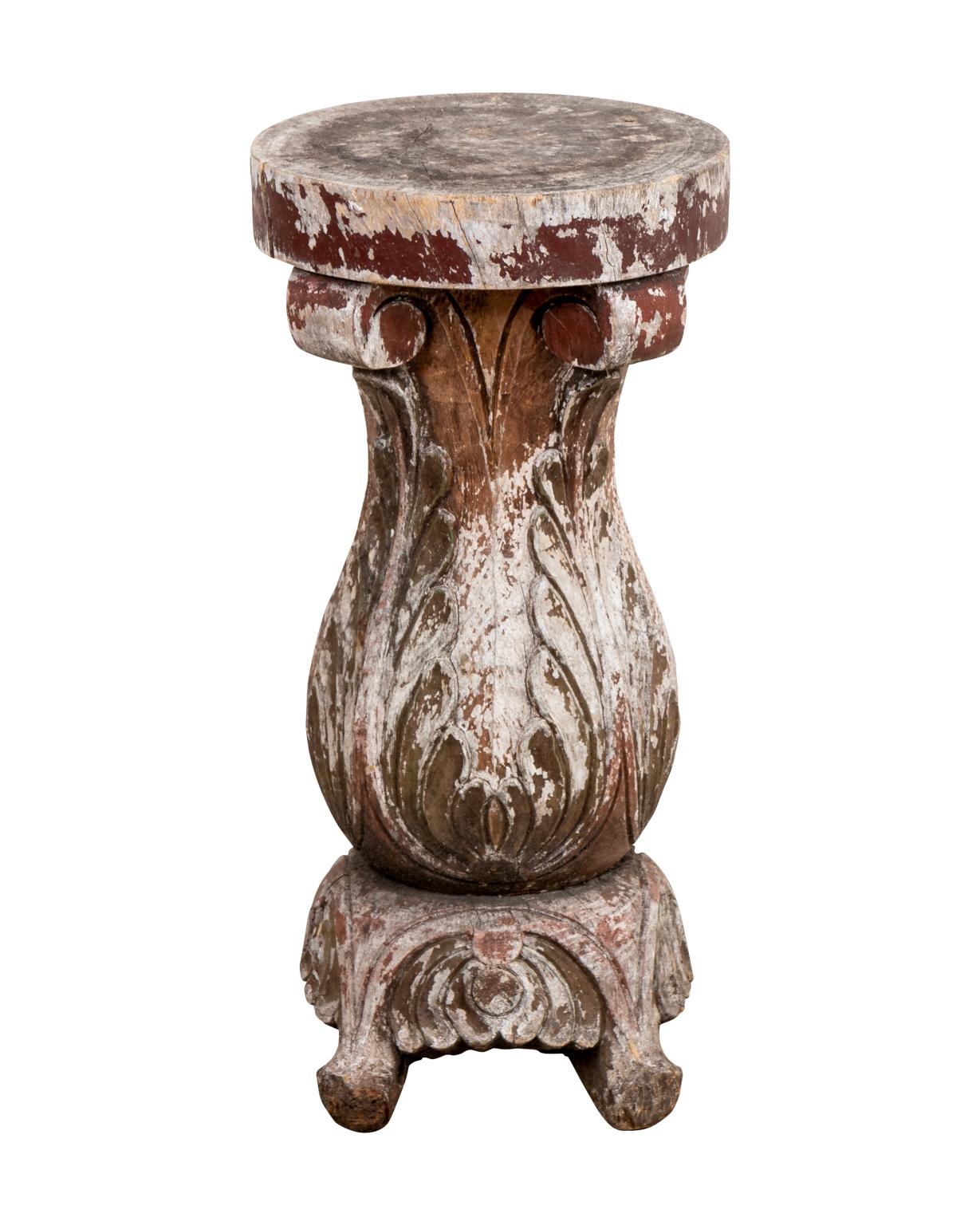 Set of three small side tables in the Hollywood Regency style made from repurposed carved wood architectural fragments in the forms of Corinthian columns and vase shaped baulisters with scrolled foliage. The tables are ornately carved and exhibit
