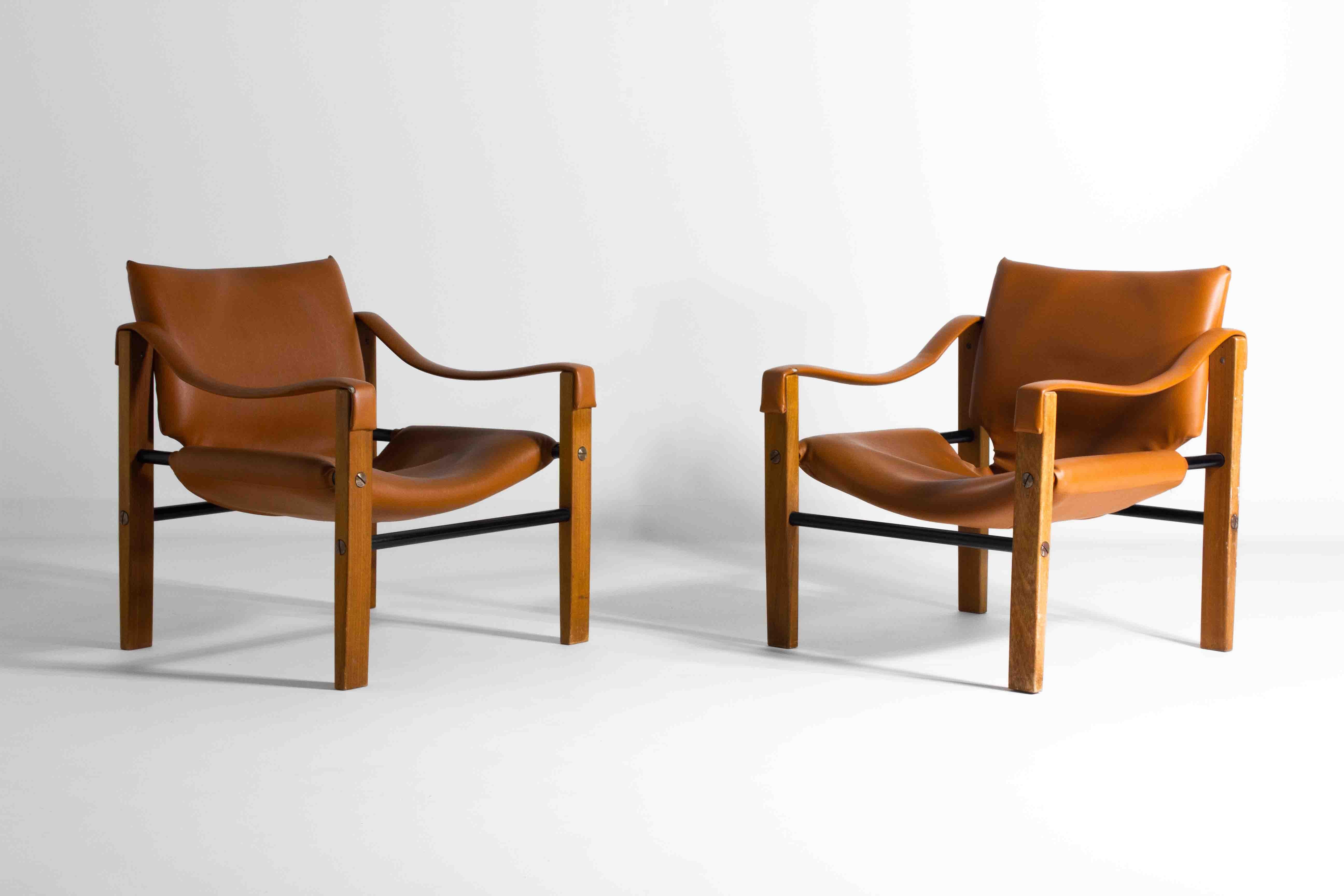 Elevate your space with this distinguished set of two cognac leather Safari Chairs by Maurice Burke for Arkana. Designed to capture the essence of adventure and sophistication, these chairs feature a rich cognac hue that exudes luxury. The sleek,