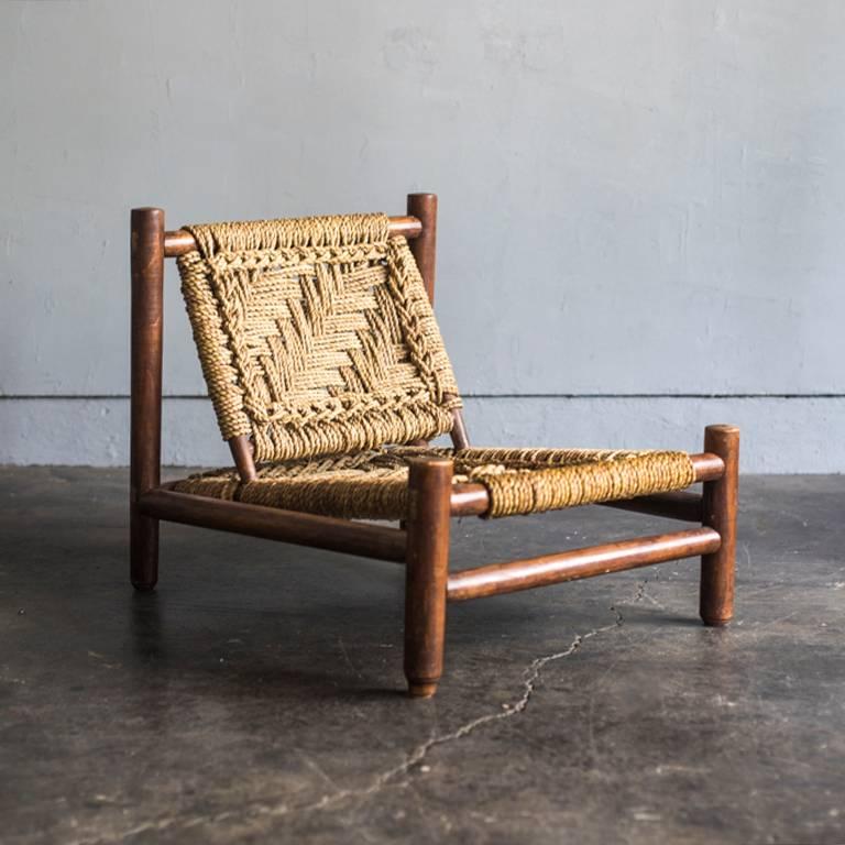 Set of an armchair and a low table by Adrien Audoux and Frida Minet.
Made in France, circa 1950s. Made of stained beech and abaca rope.
Measures: Chair: D 74, W 59, H 60 cm, SH 26.5 cm
Table: D 54, W 89, H 36 cm.