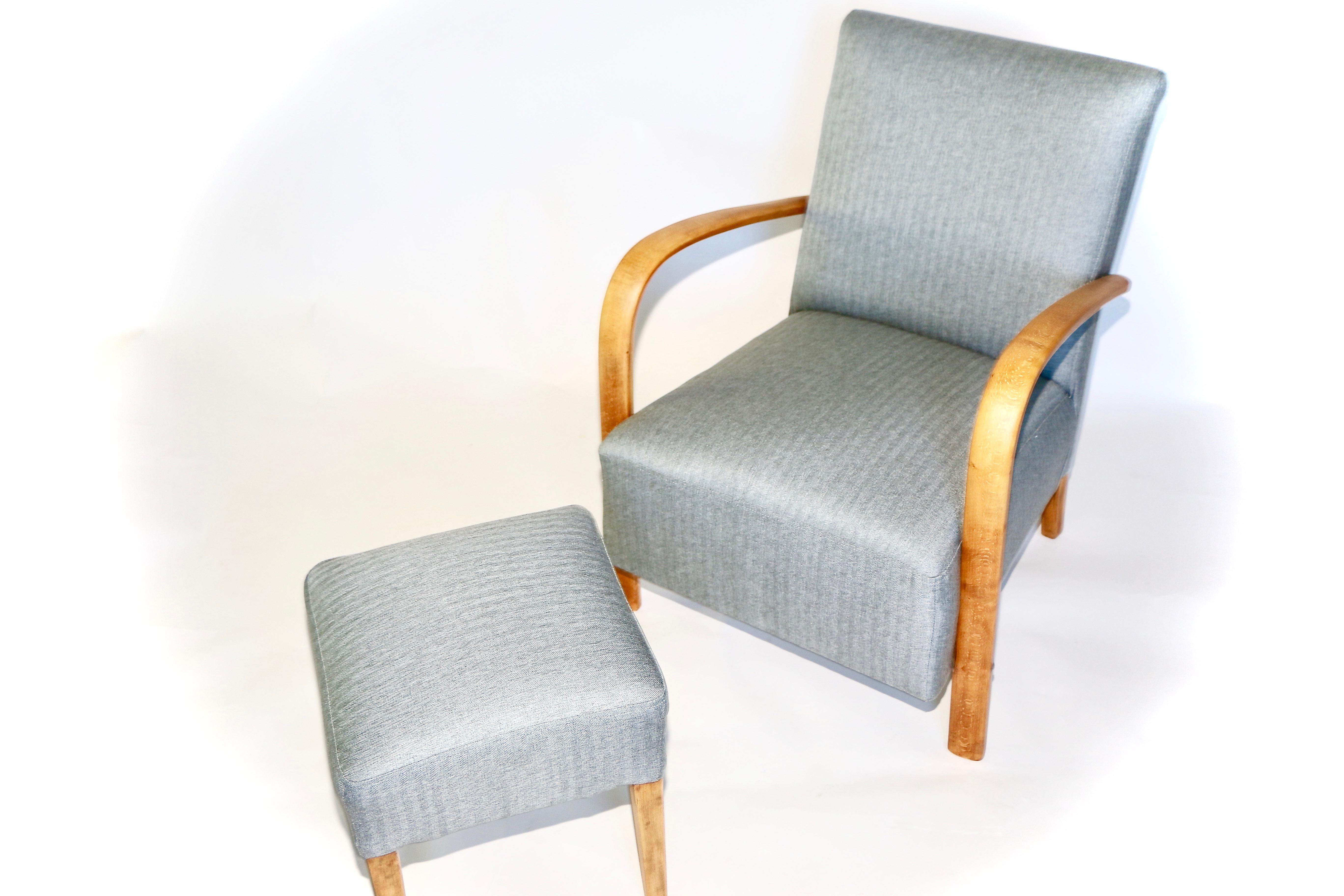 Restored Art Deco armchair with footrest seat in gray from 1960s, new upholstery covered with herringbone fabric in fashionable gray color, finished with wooden chair cushion. Wooden elements in antic wood color and beech tree. Very good