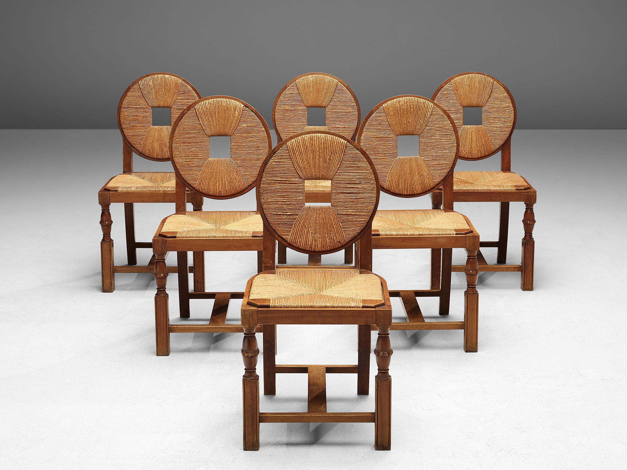 Set of six dining chairs, wicker and wood, 1940. 

Beautiful Arbus style, Art Deco dining chairs. This set has a round wicker back with a square detail it the centre, and a square wicker seat. The legs of the chair are sturdily designed, but have