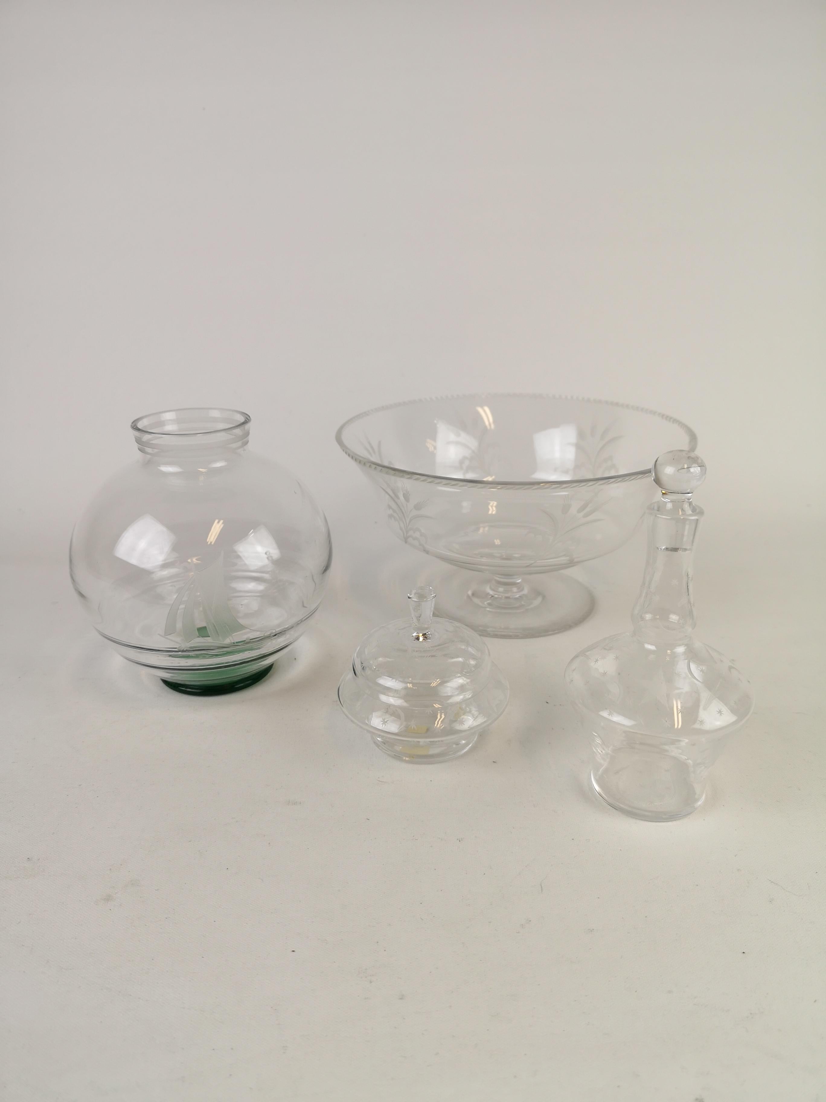 This set of 4 pieces where manufactured at Orrefors in Sweden, circa 1930s. They are what referred as Swedish Grace, the Swedish Art Deco style. They are all signed. The items are one round vase, a bowl, one small bottle and one small bowl with a