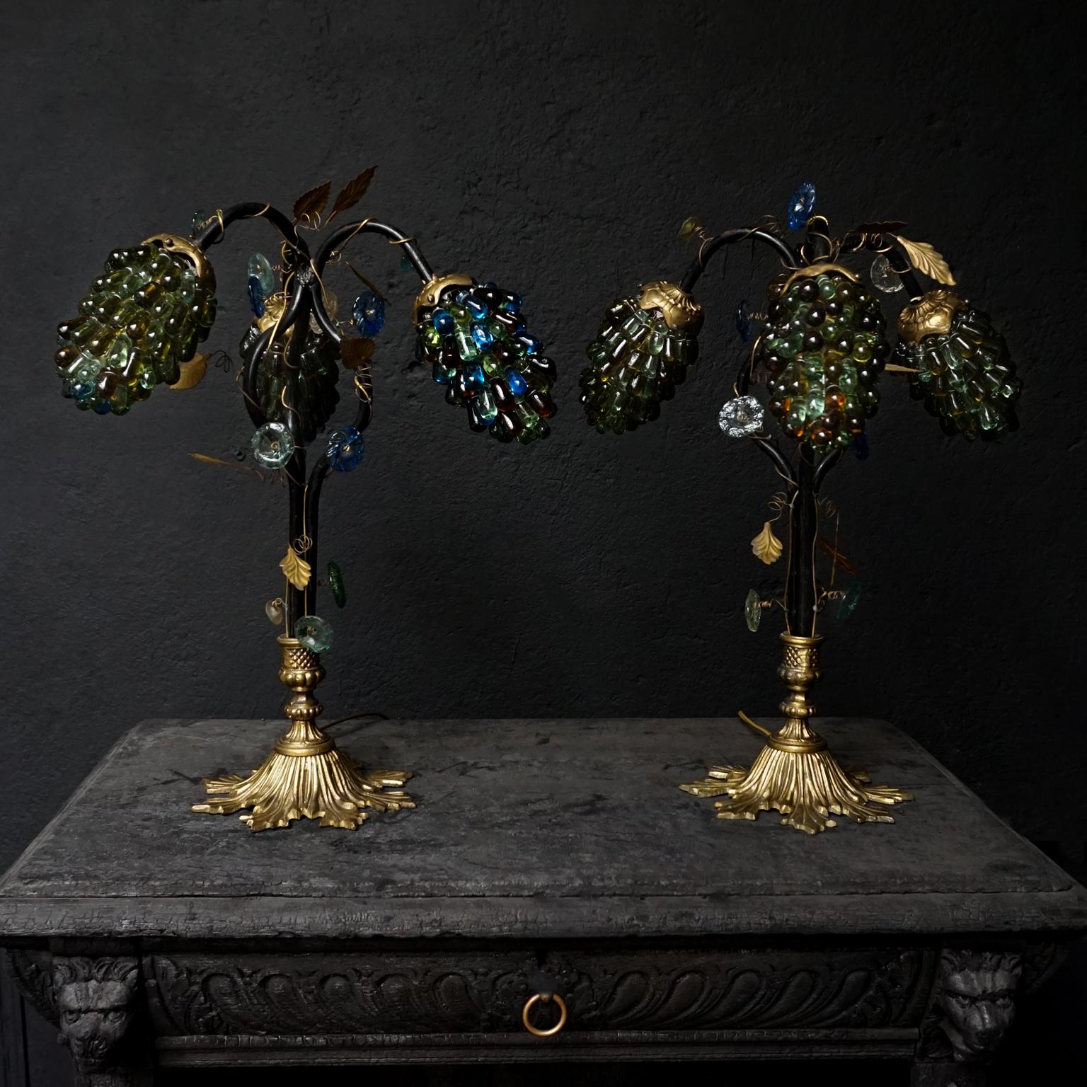 Two 1930s Art Nouveau Italian cluster table lamp shades with three colorful branches of grapes, perfectly formed from hand blown Murano glass. These lovely lights are on a heavy bronze standard shaped like a large leaf. The three arms are made from