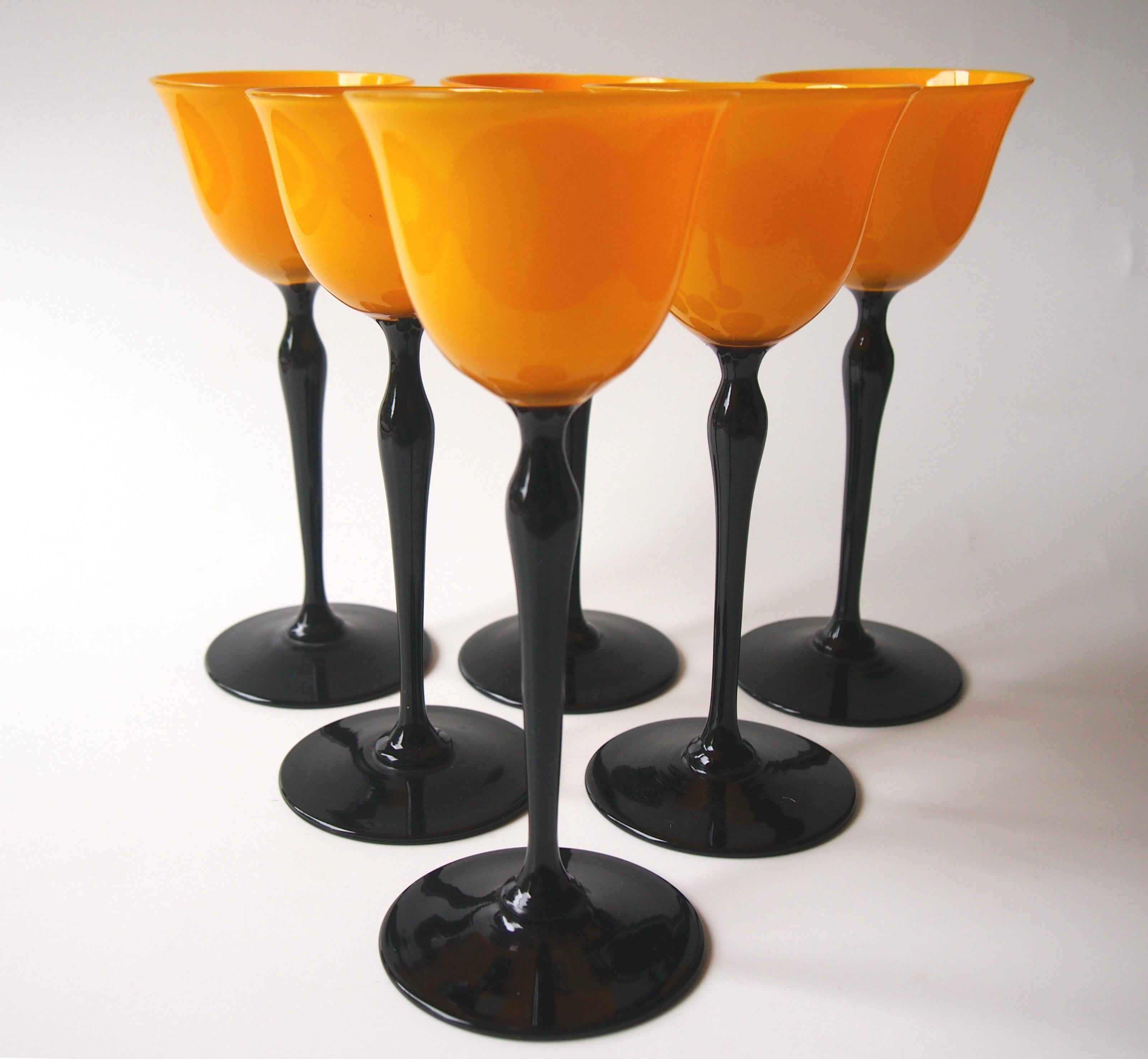 Dramatic set of six 'Tango' Art Deco Harrach wine glasses in vibrant orange on black stems. Bohemian Tango ware was very popular in the USA in the 1920s and 30s and it was made by many companies. It's unusual to be able to identify such pieces to a