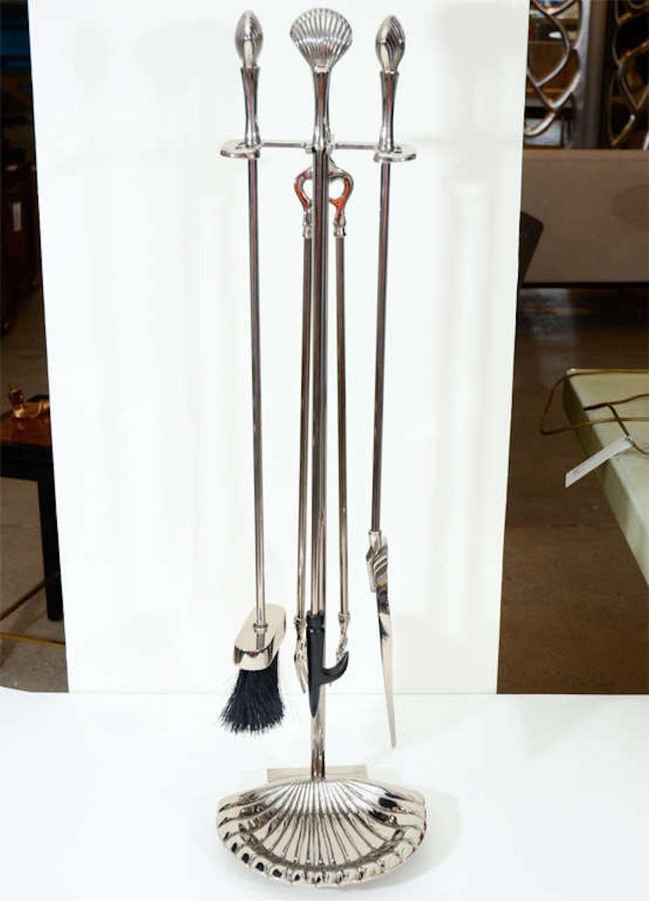 Exceptional set of polished nickel fireplace tools with stylized shell handles and base. Recently professionally polished.