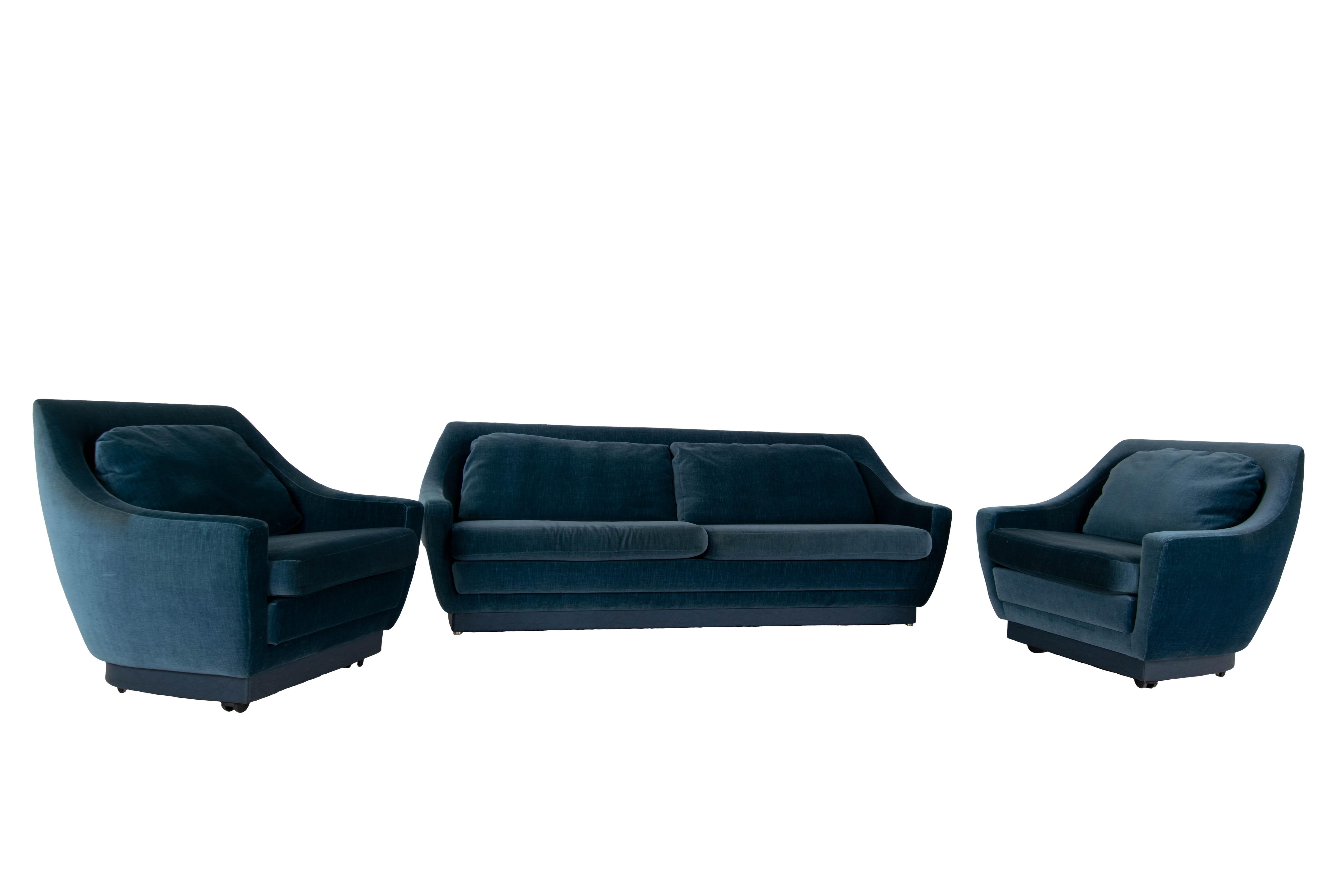 An impressive set of Art Deco style Sofa and Two Lounge Chairs. This set is very professionally upholstered in 1988 by 'Bröring Interieur B.V'. in Amsterdam. It has blue velvet fabric with an edge on the bottom in blue leather. The sofa easily sits