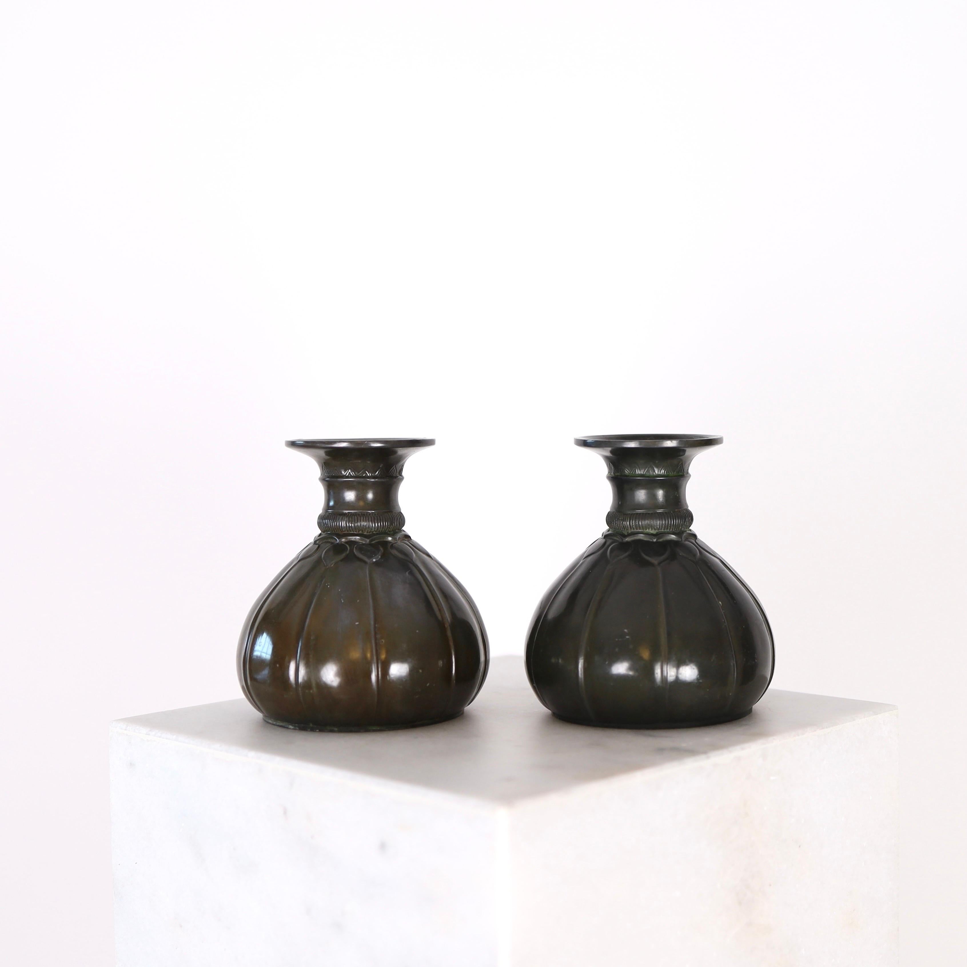 A rare set of metal vases designed by Just Andersen in 1920s. These early-work pieces by Just Andersen are in very good vintage condition and a true testament to the Danish design heritage and craftmanship. 
 
* A pair of metal vases 
* Designer: