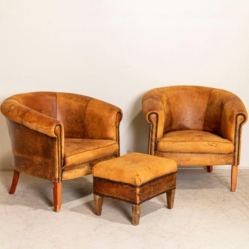 Vintage leather club chairs are highly sought after these days for those seeking to add an aged element to a modern home. This attractive set will do just that; they are scaled on the small side so will fit in a variety of settings. This pair of