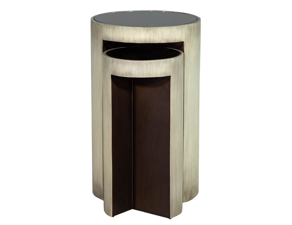 Set of Baker Maguire moon modern accent tables. Cylindrical table set that fit together. White bronze metal with bronze mirror top and blackened steel accents.
Price includes 1 set, large and small table - 2 sets available.
Price includes