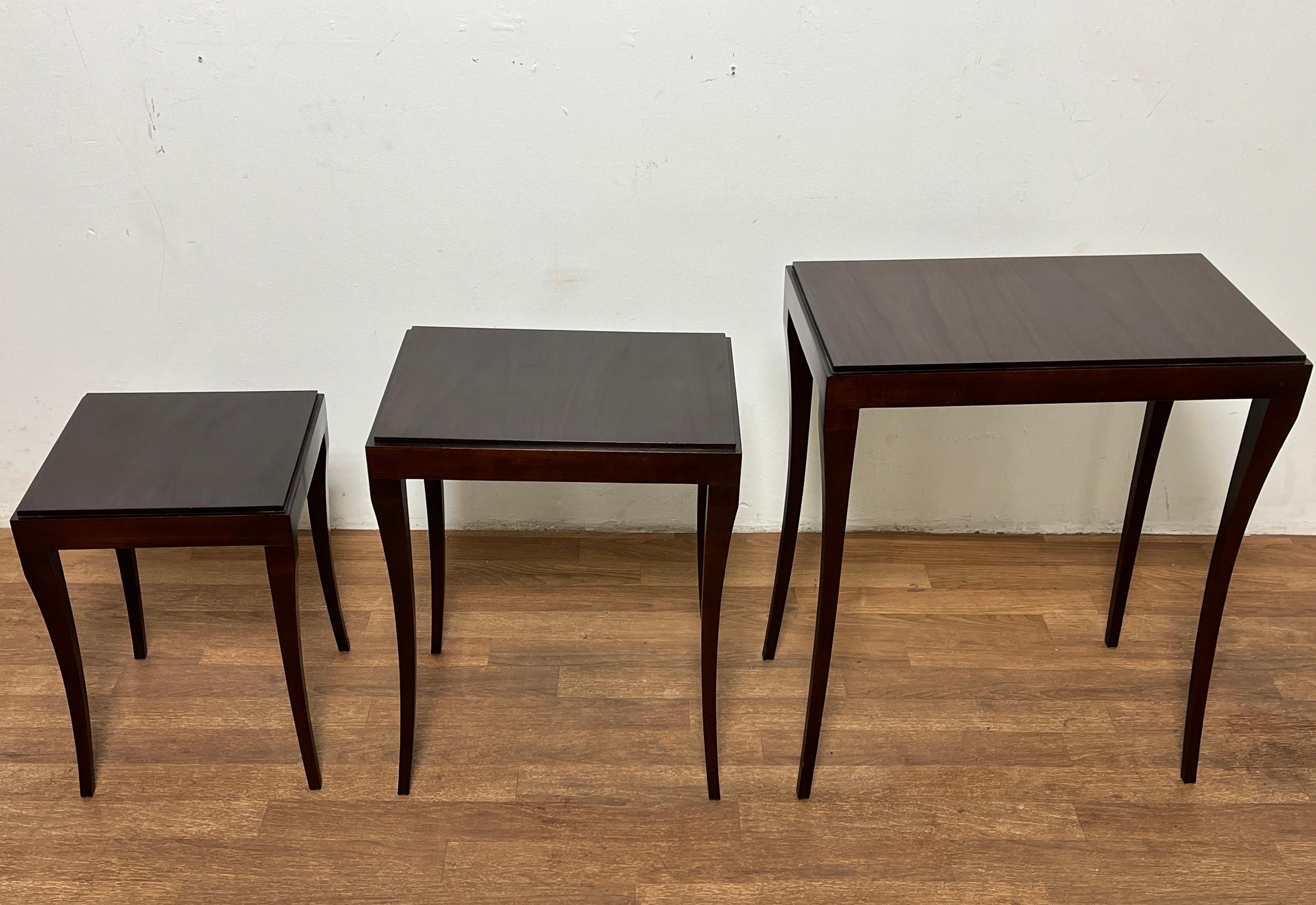 Set of three nesting tables in mahogany with elegantly curved legs, designed by Barbara Barry for Baker Furniture, circa 1980s.

Largest table measures 24