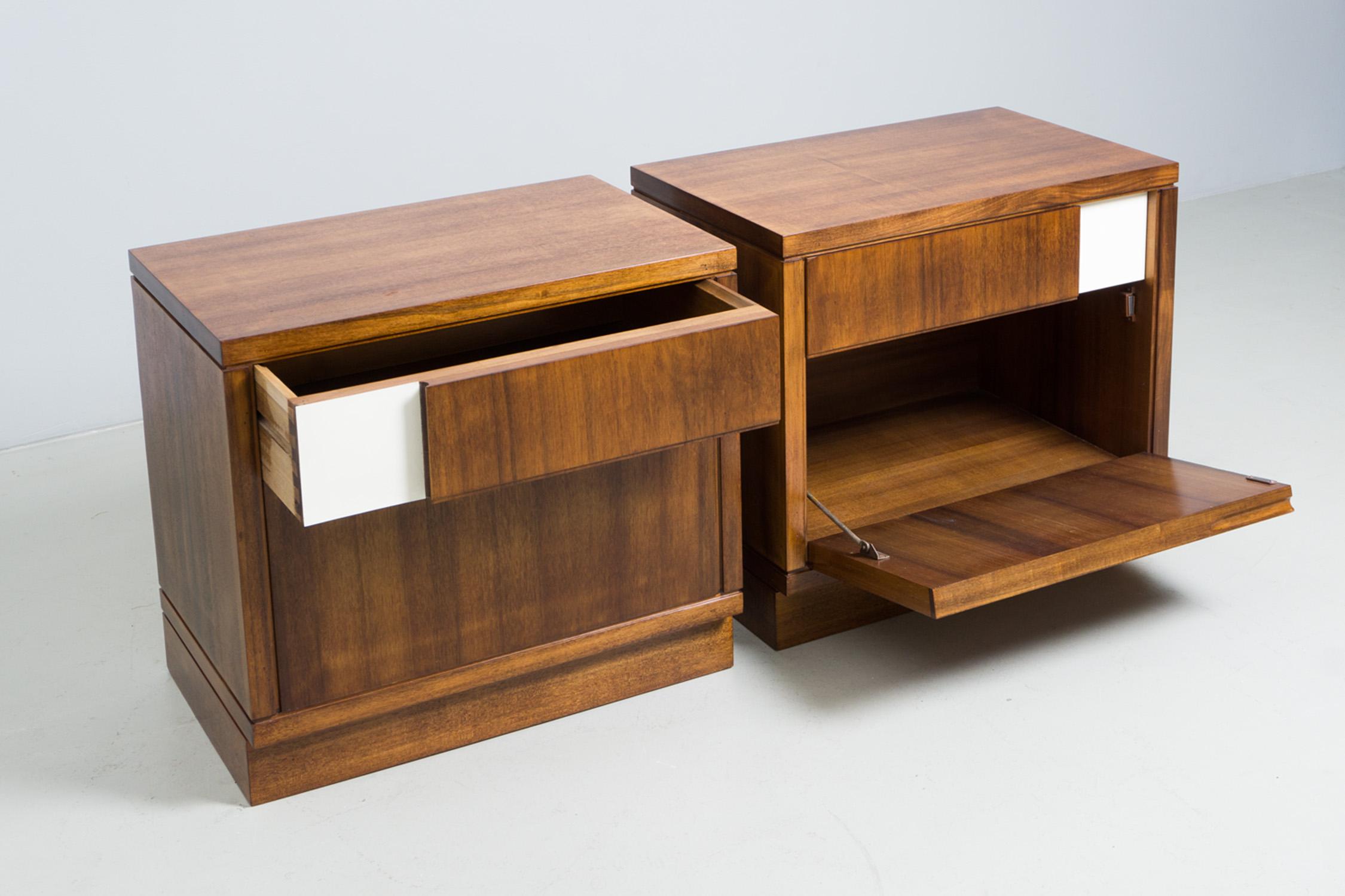 Two night stands made of wood and walnut veneer, with Formica elements in white. Drawer on top and lower compartment with fold out door. Designed by Ico Parisi. Manufactured by Brugnoli Mobili Cantú.
