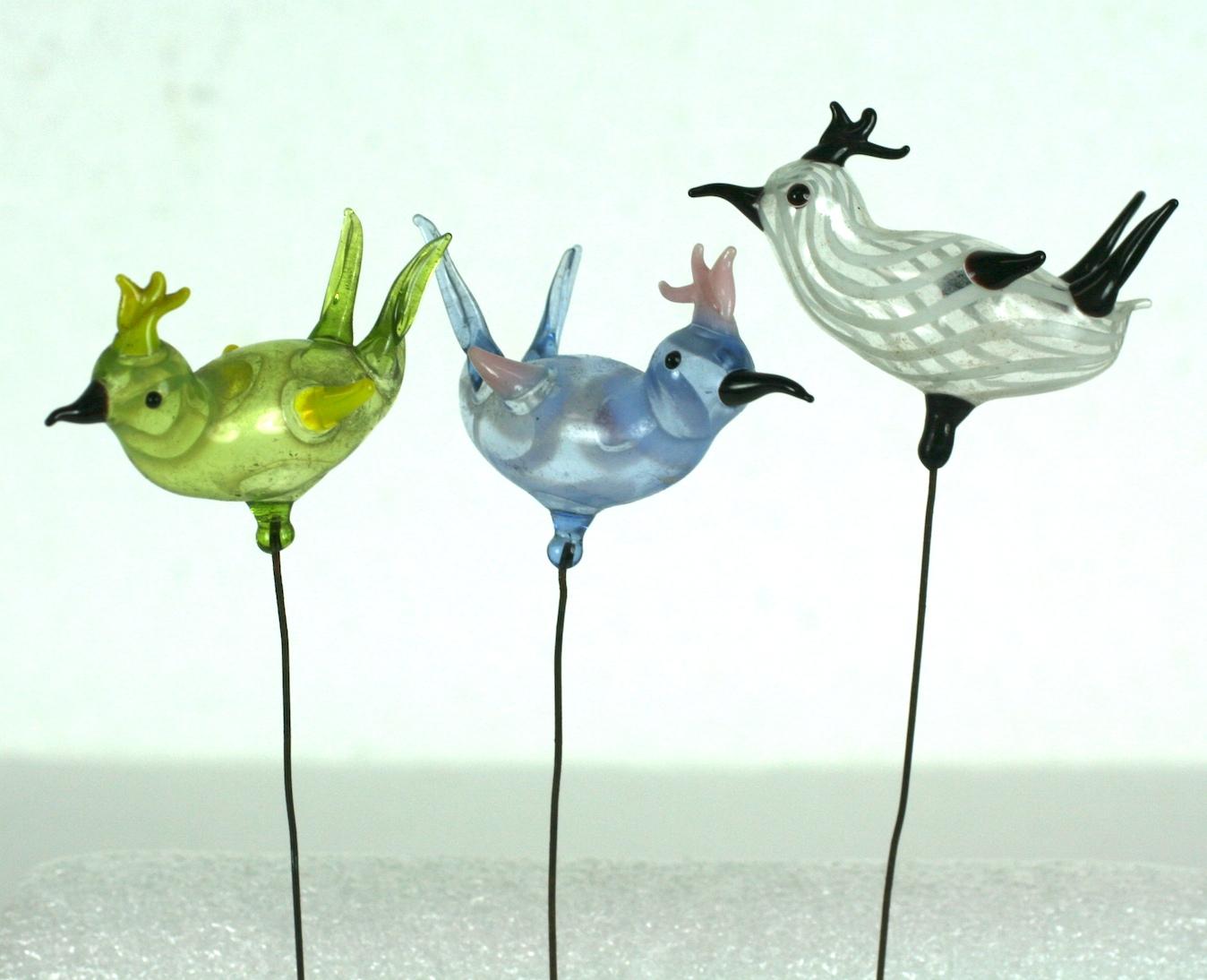 Bimini hand blown birds on metal staffs from the Art Deco area. One each in blue, Lime green and striated white, would work beautifully in a diorama, 1920s, Germany.
Measures: Birds 5