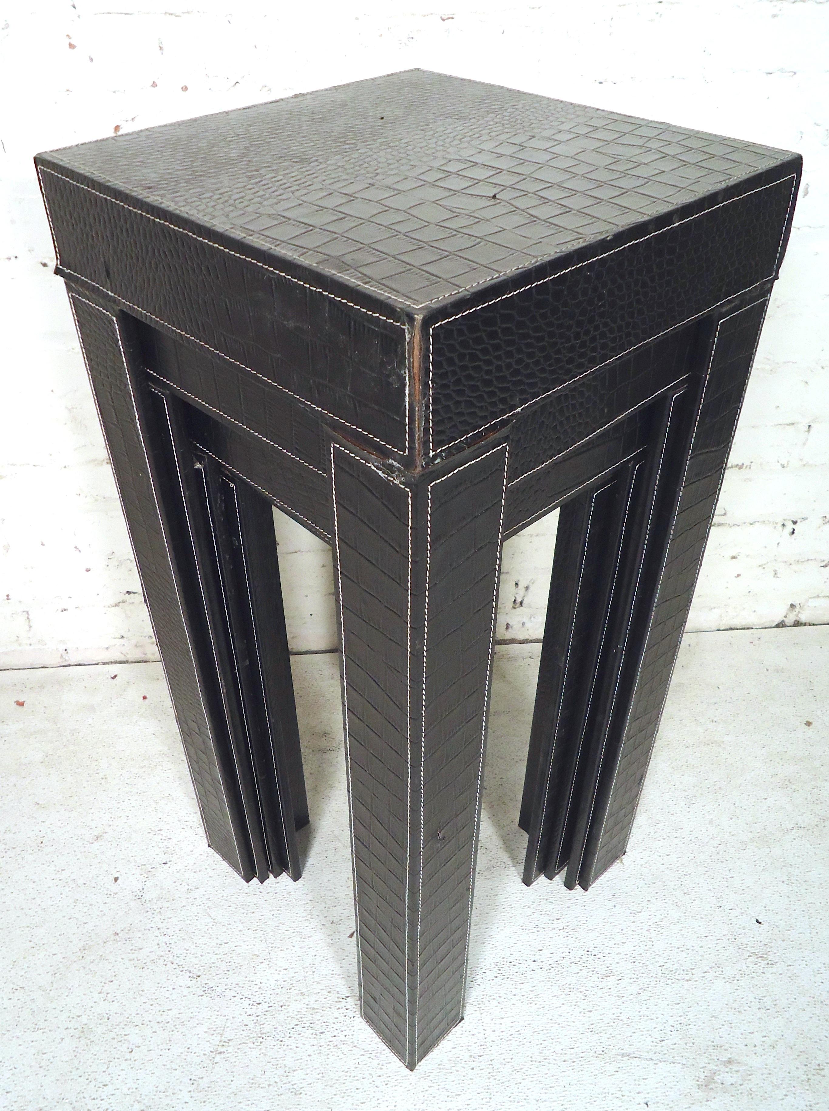 This sleek set of Mid-Century Modern nesting tables featured in black leather would make a great addition to any home or office.

 Please confirm item location (NY or NJ).