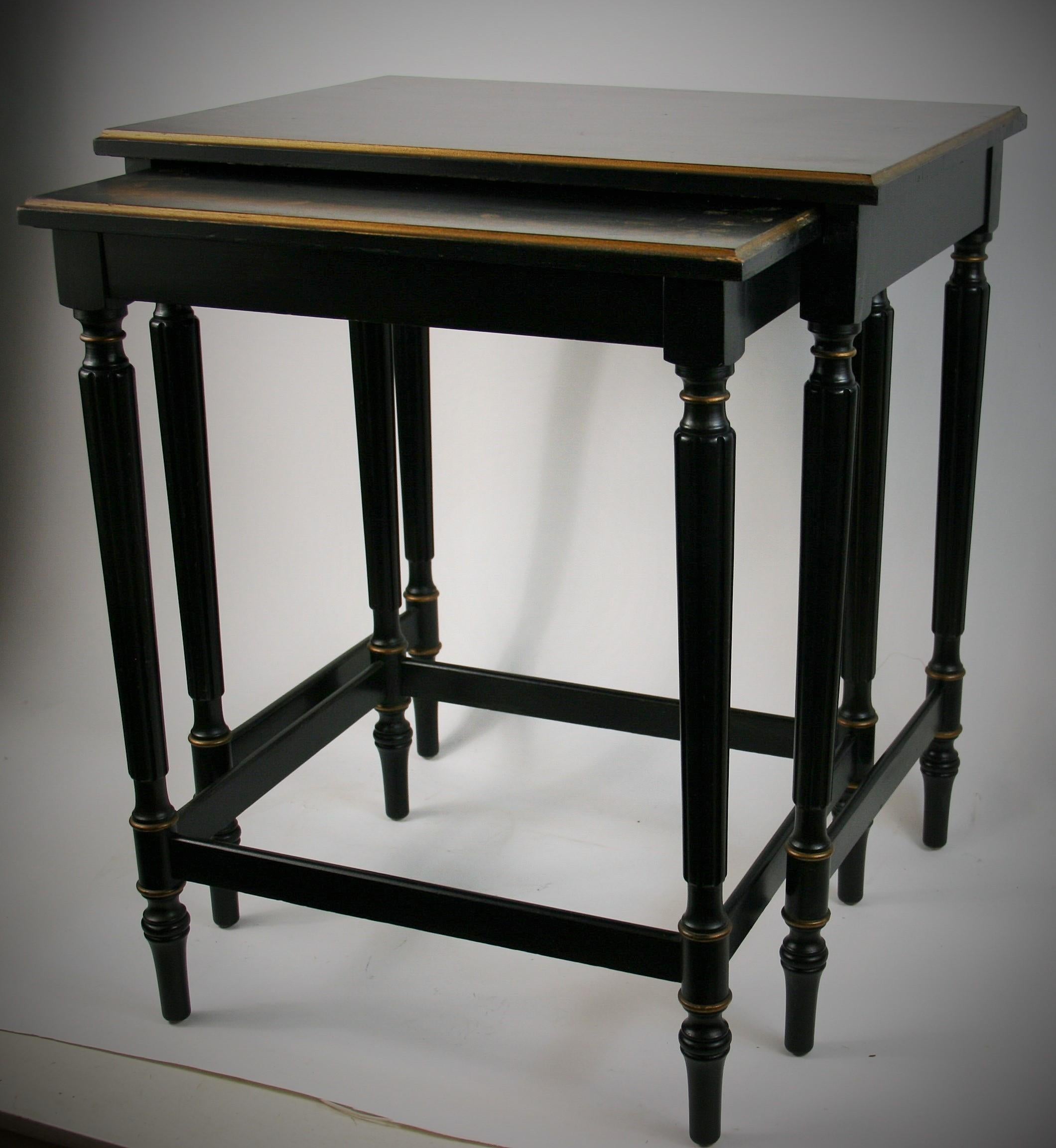 2-305 two black nesting tables by Imperial Furniture of Grand Rapids Michigan, circa 1950.
Fluted legs with floral gilding details on top surfaces.
Minor scratches on top surfaces.