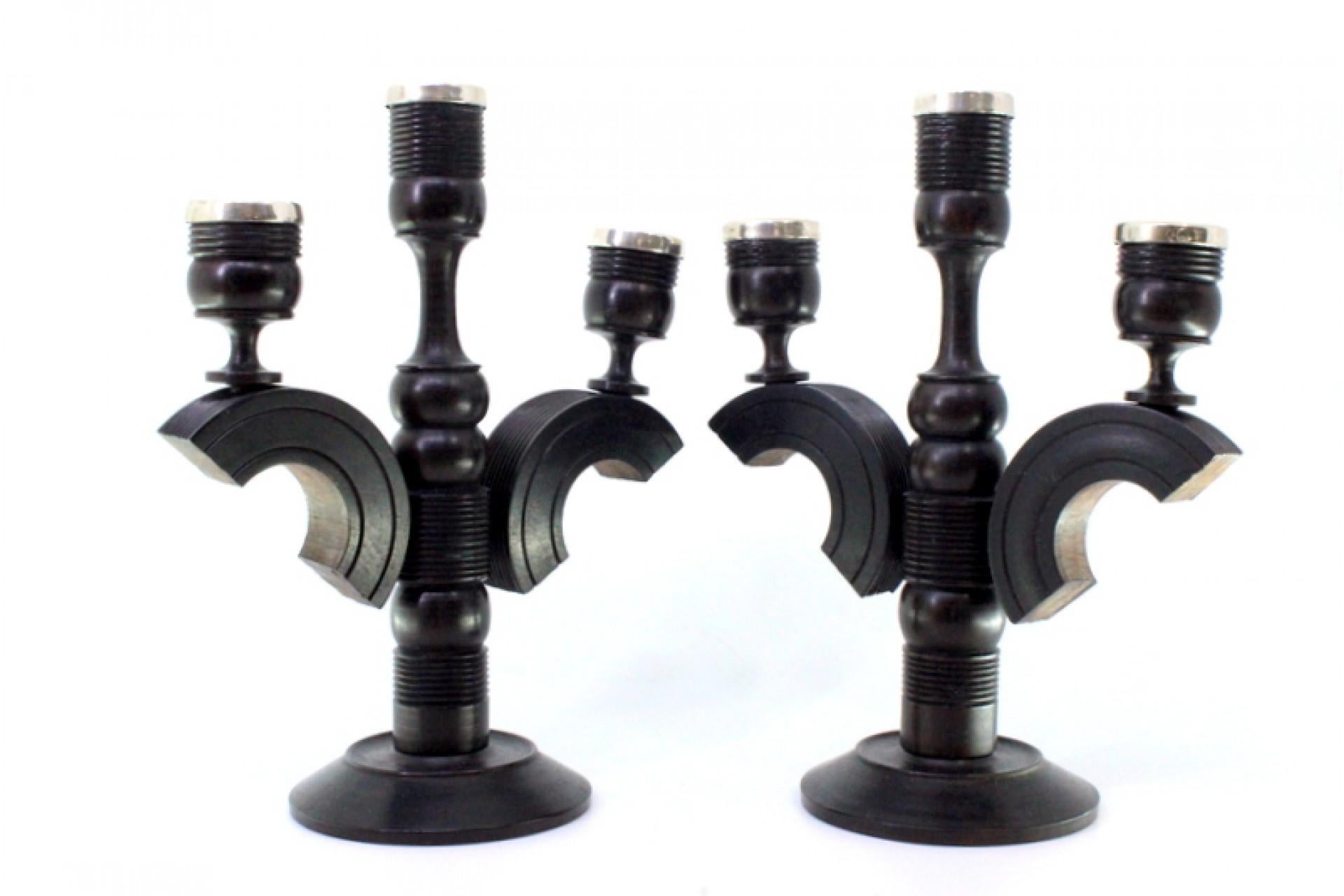 Description: Set of black wood candelabras with silver applications on the shafts. Metal: Silver. Origin: European. Brand: Unknown. Weight: 853.21 grams. Dimensions: 17.5cmx22cm. Content: 925/1000. Assay Mark: Yes. Additional information: Good