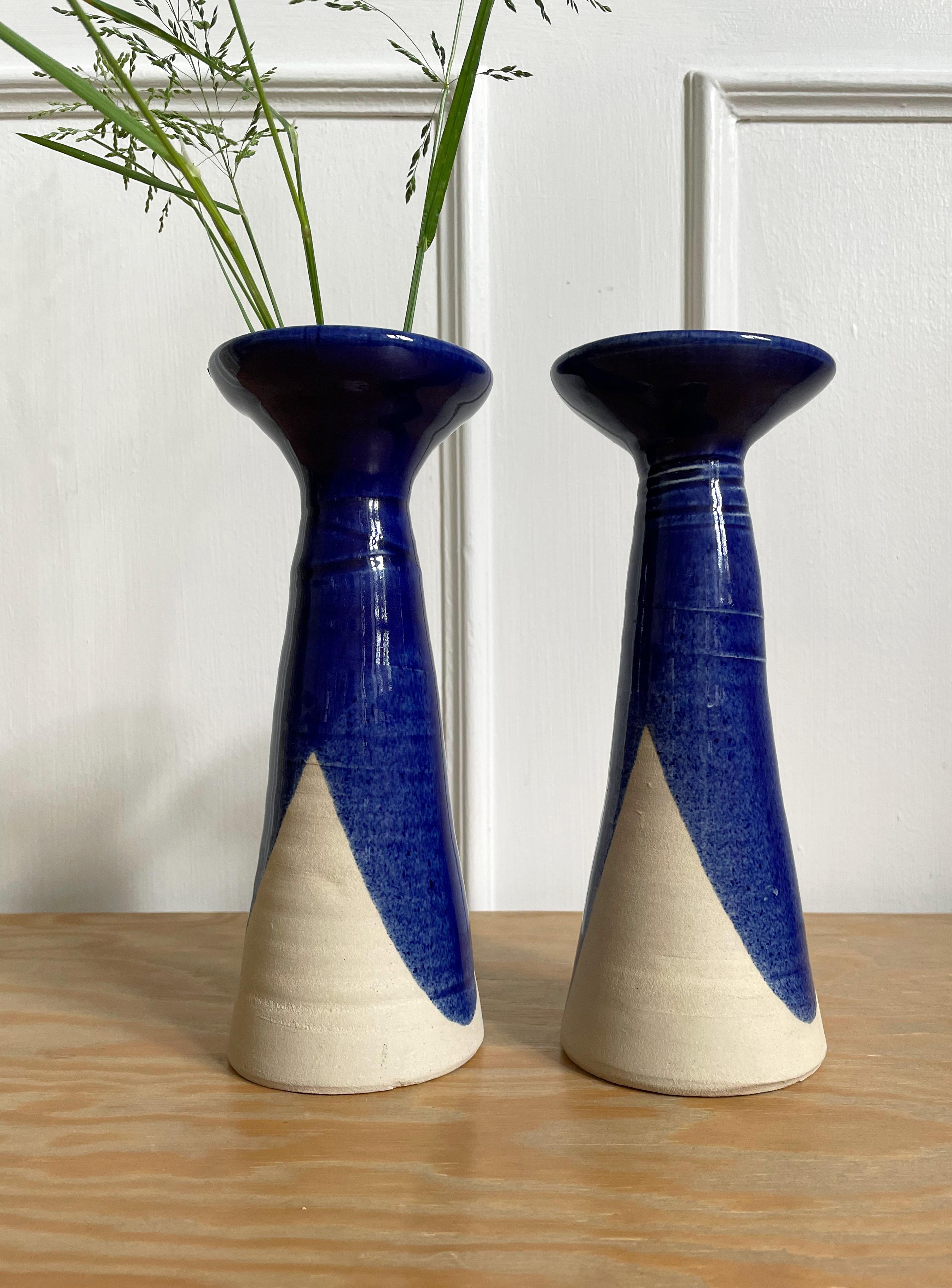Tall pair of shiny admiral blue glazed candle holders / vases manufactured in Denmark in the 1980s. Asymmetrical, graphic glaze. Raw base. Beautiful vintage condition. 
Denmark, 1980s. 