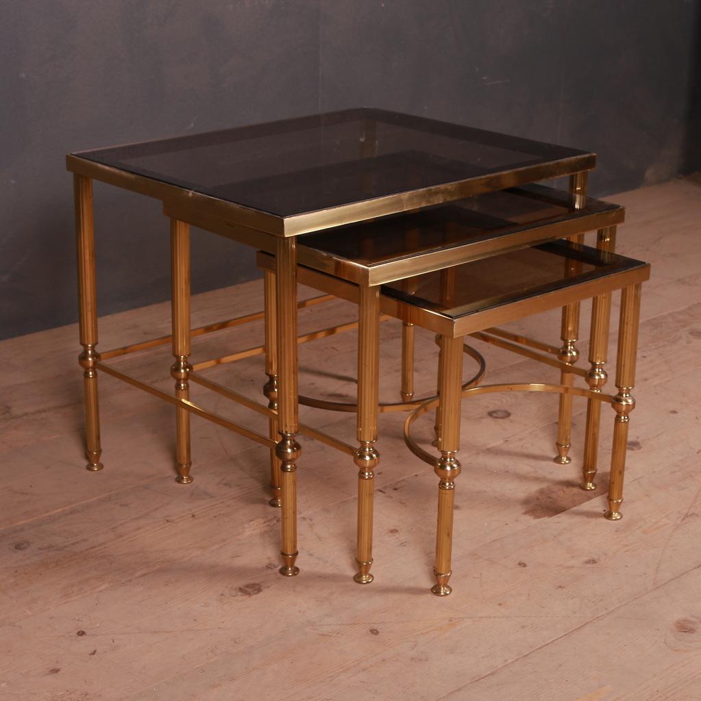 Set of brass and glass tables with smoked glass top. 1950.

Dimensions of largest table =
22