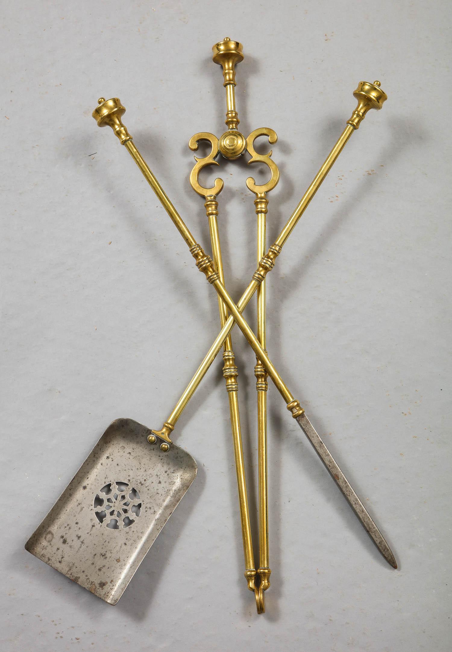 Fine set of English 19th century brass and steel fire tools having turned turret handles, the shovel with pierced steel basin having snowflake decoration.