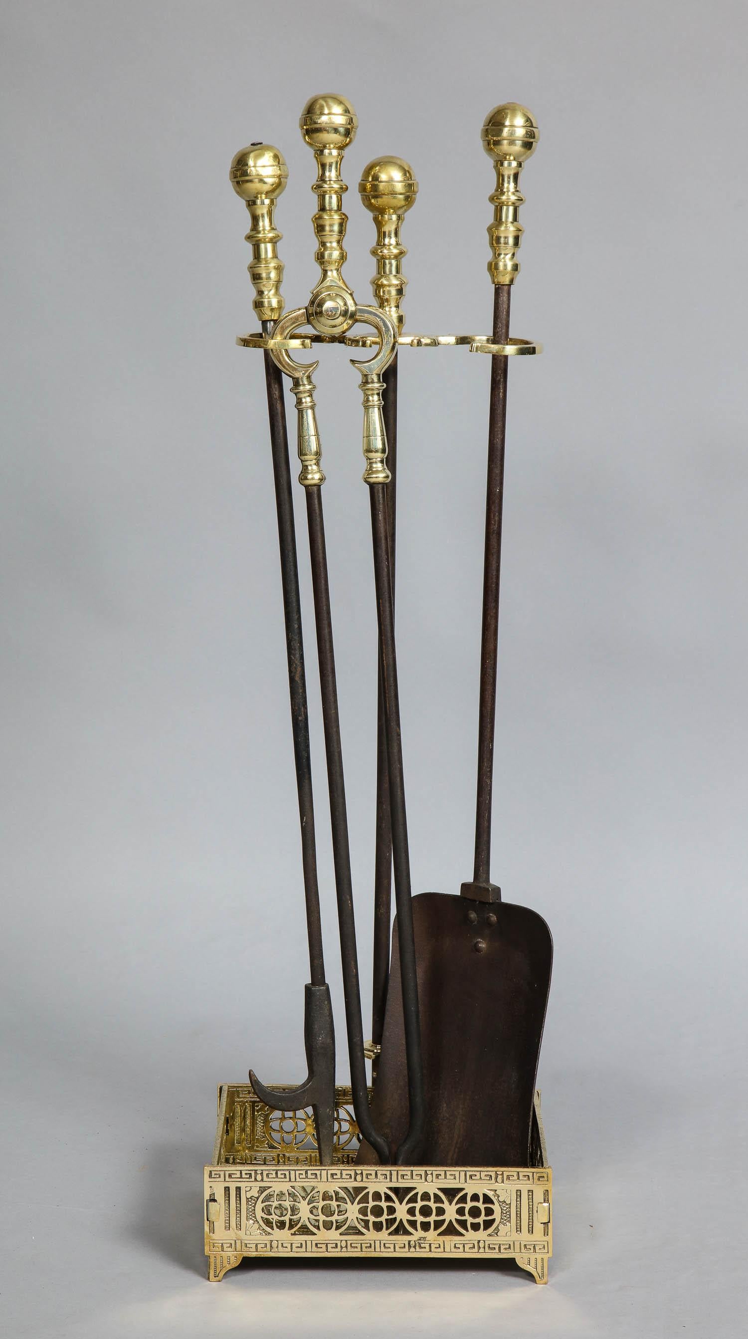 Good set of 19th century brass and blackened wrought iron fire tools and matching stand having ball finials and ring turned handles, the square base with interesting pierced decoration.

Measures: Stand: 9