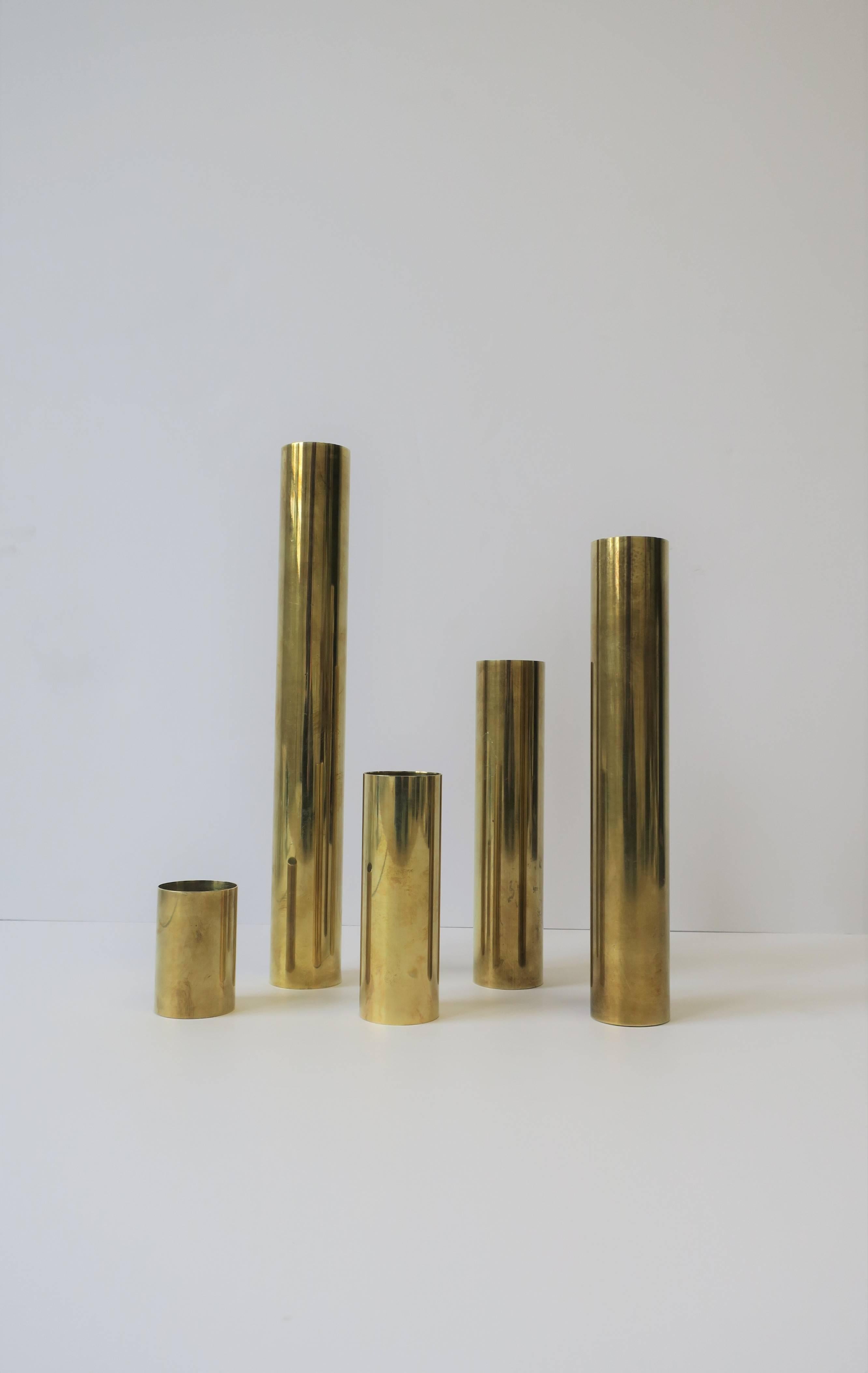 A set of five, versatile, modern style brass cylindrical sculpture vessels, circa late 20th century. Vessels are strategically weighted at bottom. Side table shown in image #3 also available; search ID #: LU1314211182461

Height measurements:
12.25