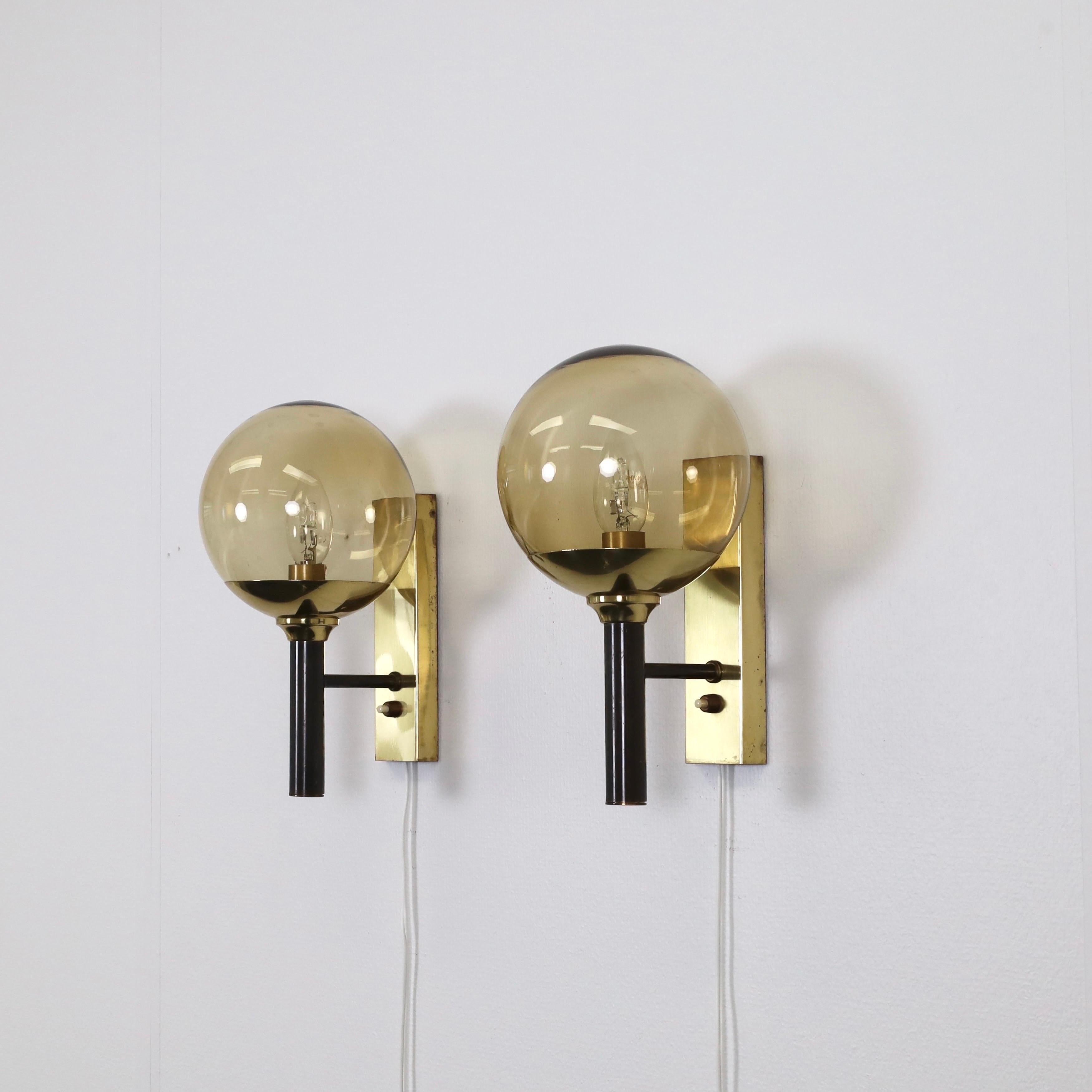 Set of Brass Sconces with Smoke-Colored Glass shades made by Svend Mejlstrøm in the 1960s. A classic set for a beautiful home. 

* Set (2) of brass wall sconces with smoke-colored glass shades
* Designer: Svend Mejlstrøm
* Style: 803
* Manufacturer: