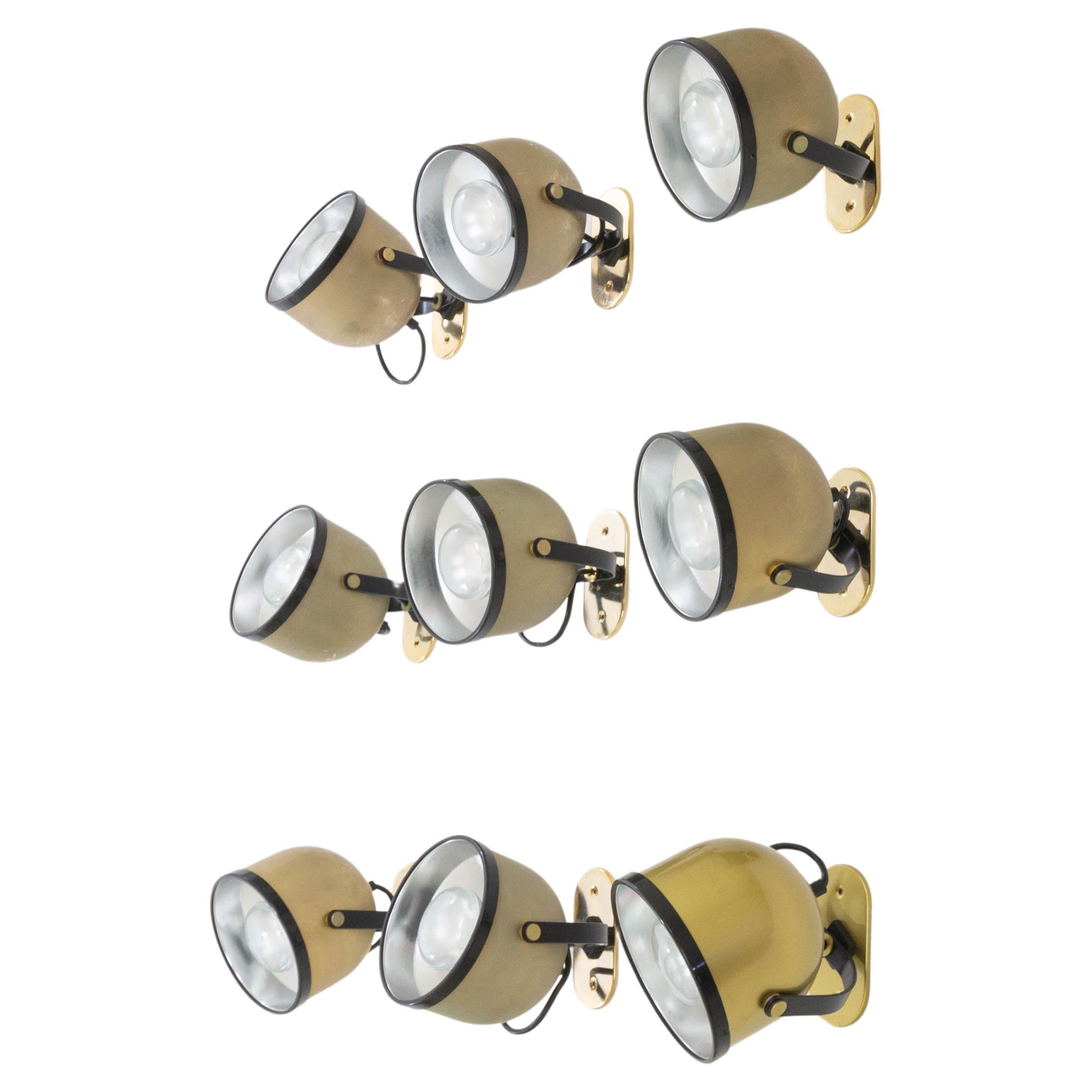 Set of nine brass swiveling spots designed by Gae Aulenti and Livio Castiglioni for Stilnovo in the 1970s. The spots can be used as wall lamps and as ceiling lamps.

The spots or projectors are fitted with a double rotation movement, allowing them