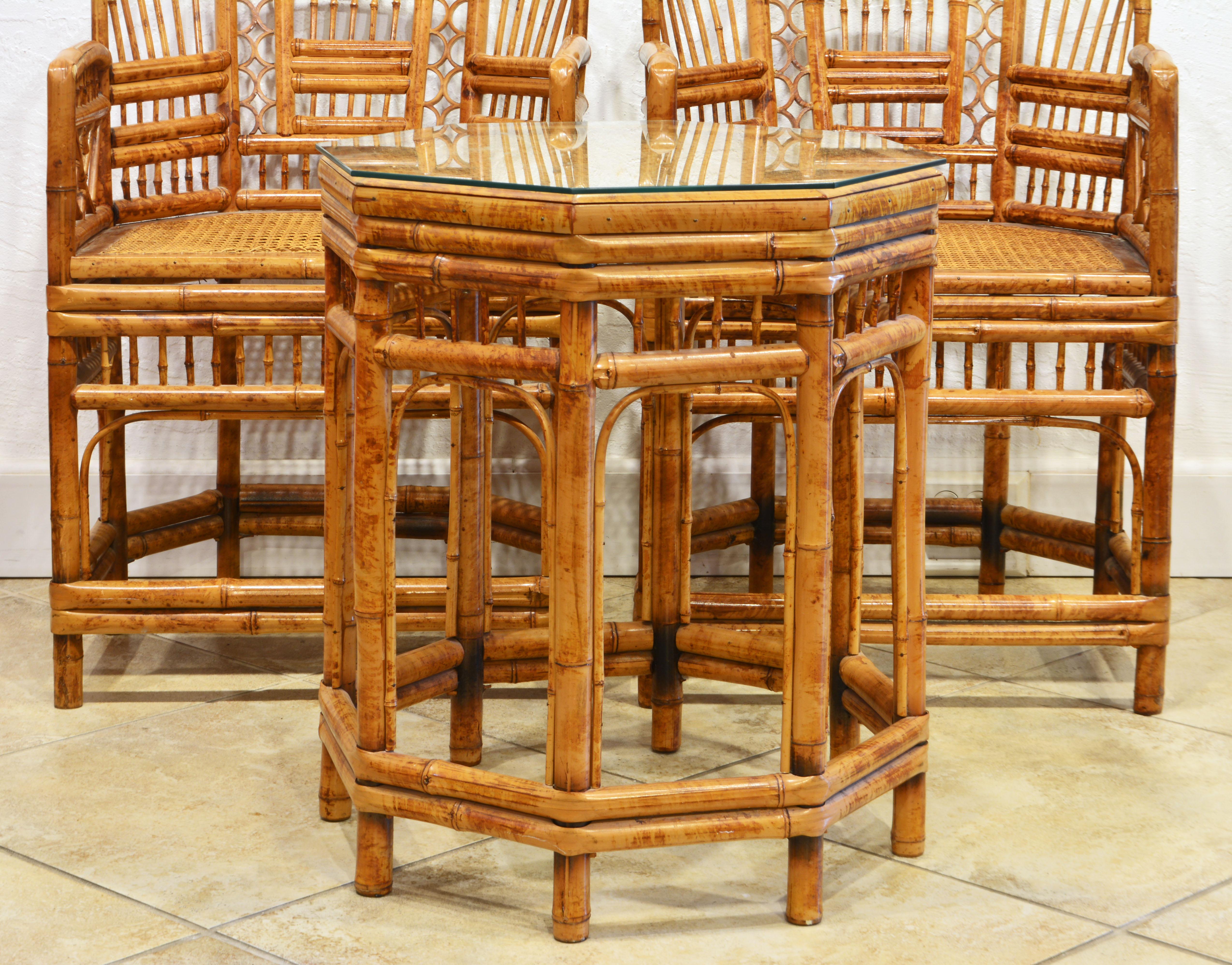 A pair of vintage iconic Brighton Pavilion chinoiserie style bamboo arm chairs and a matching octagonal glass top bamboo table. A rare find. The measurements below pertain to the chairs. The table measures 20.5 x 20.5 x 25 inches.