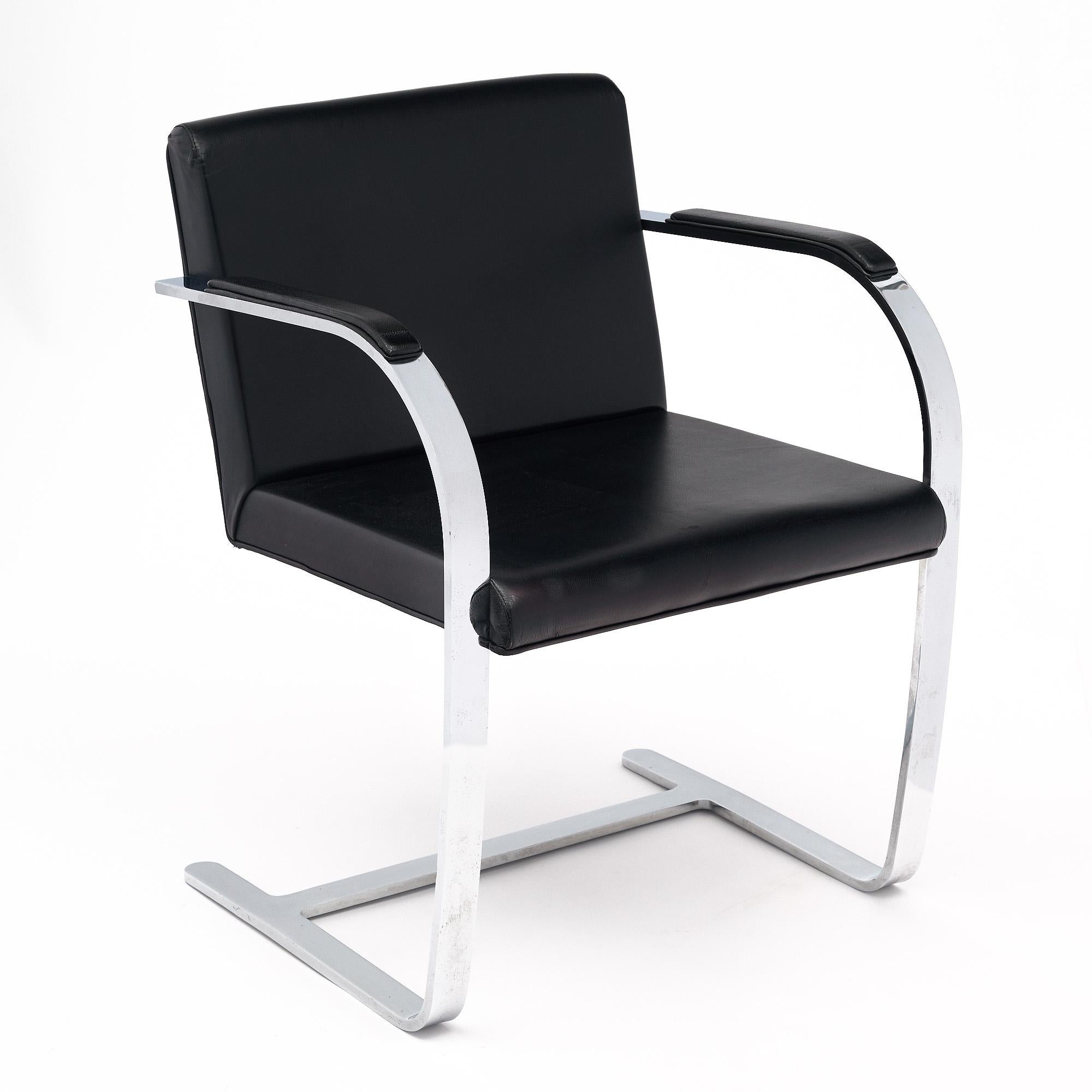 Set of four Brno chairs by Mies van der Rohe for Knoll. This set has the classic chrome structure with the original flat bar design. The upholstery is all black leather. These chairs were originally designed for his Tugendhat house in Brno, Czech