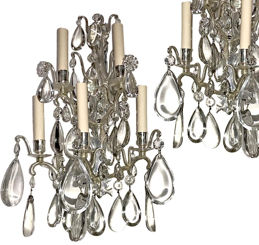 A set of four circa 1920s, French 5-arm bronze sconces with crystal drops and five lights. Sold per pair.

Measurements:
Height: 21